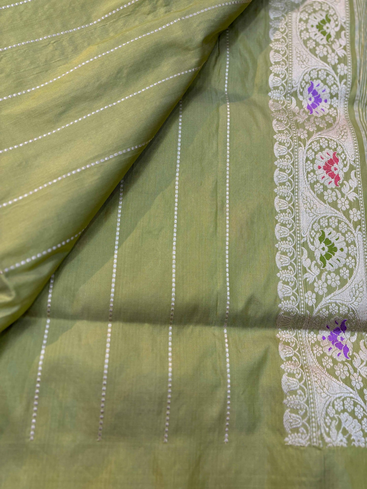 Light green Banarasi handloom saree with striped field and ornate right-side border