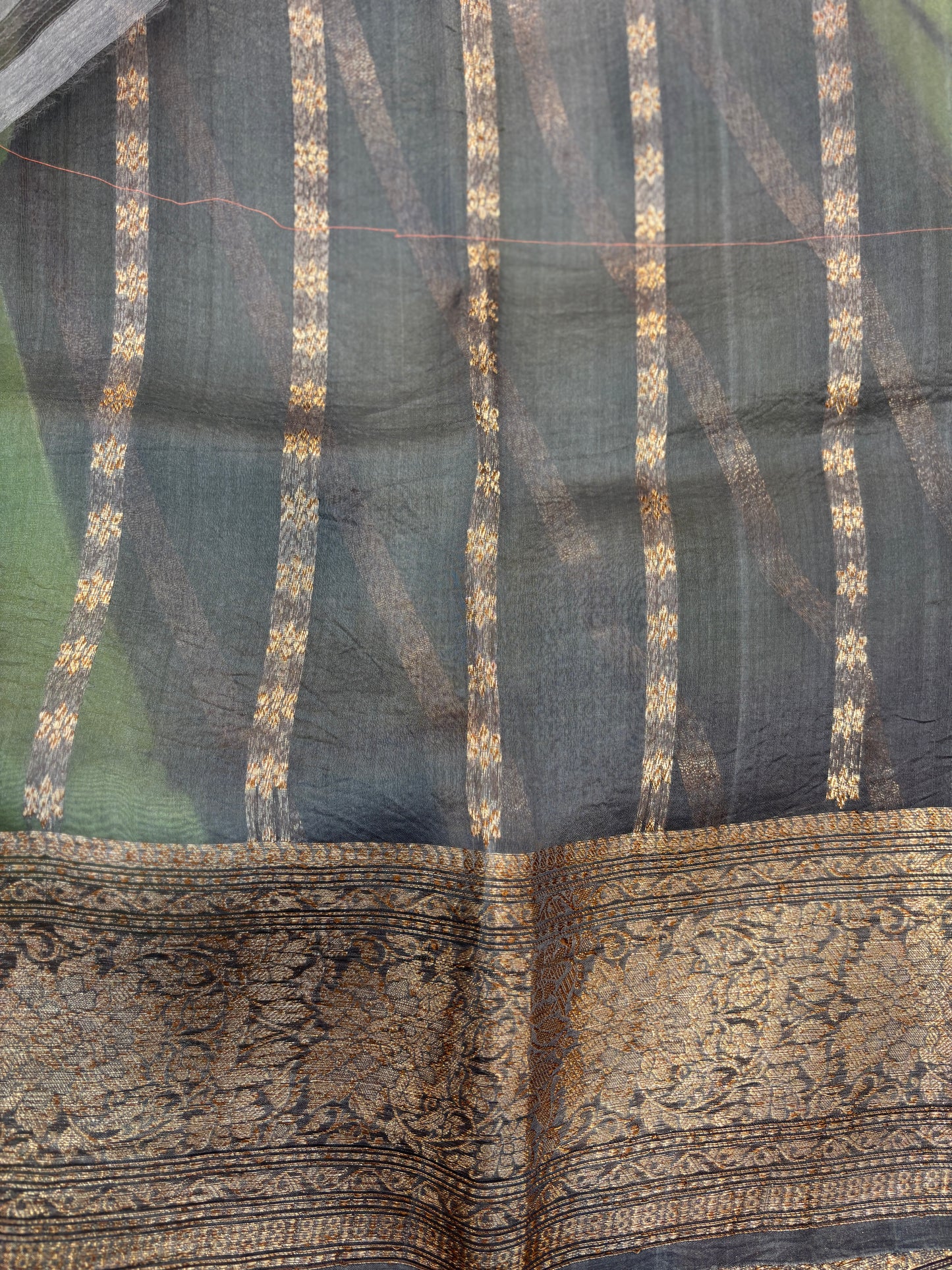 Charcoal silk saree with gold woven stripes and ornate zari-style border