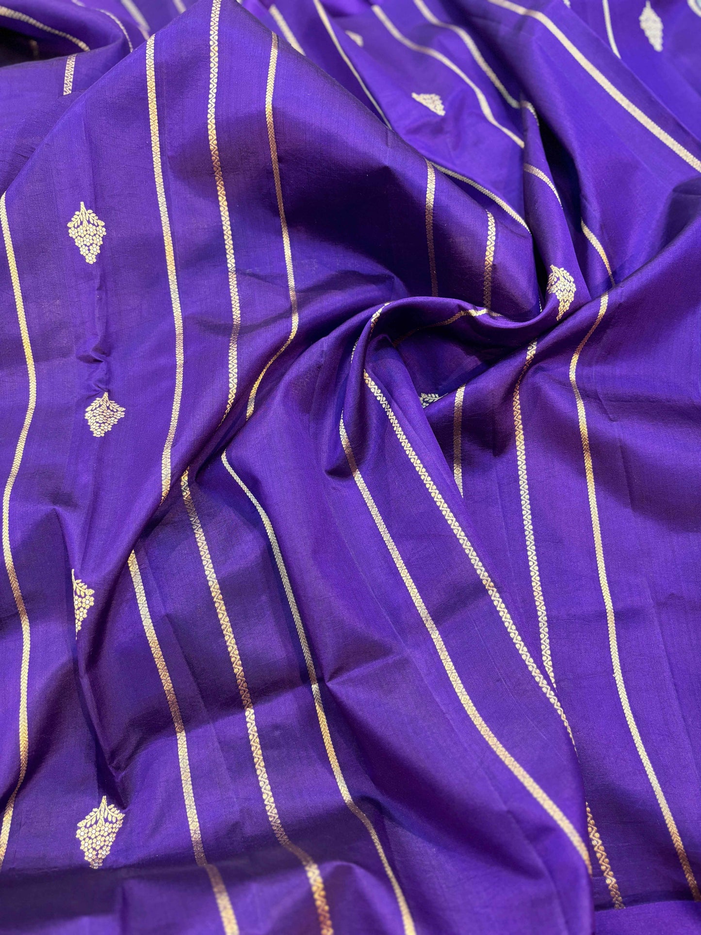 Purple Banarasi handloom saree with woven gold motifs and long stripe lattice