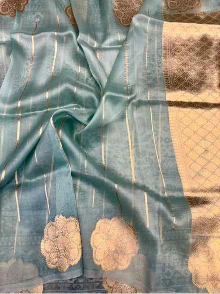 Powder blue Kora tissue Banaras saree with gold stripes and beige floral motifs