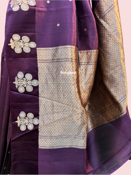 Dark wine Banarasi saree close-up pallu with gold woven border and floral medallions
