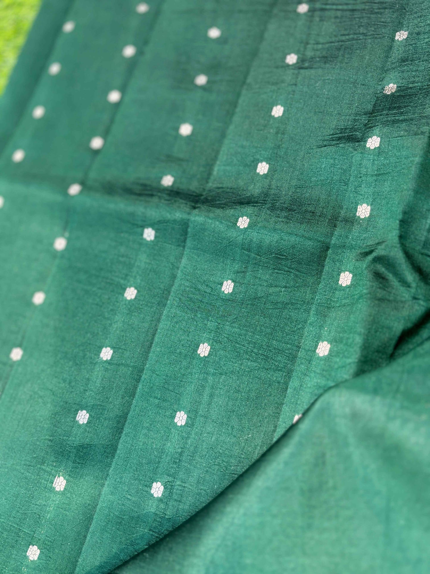 Green saree with small scattered motifs and smooth drape
