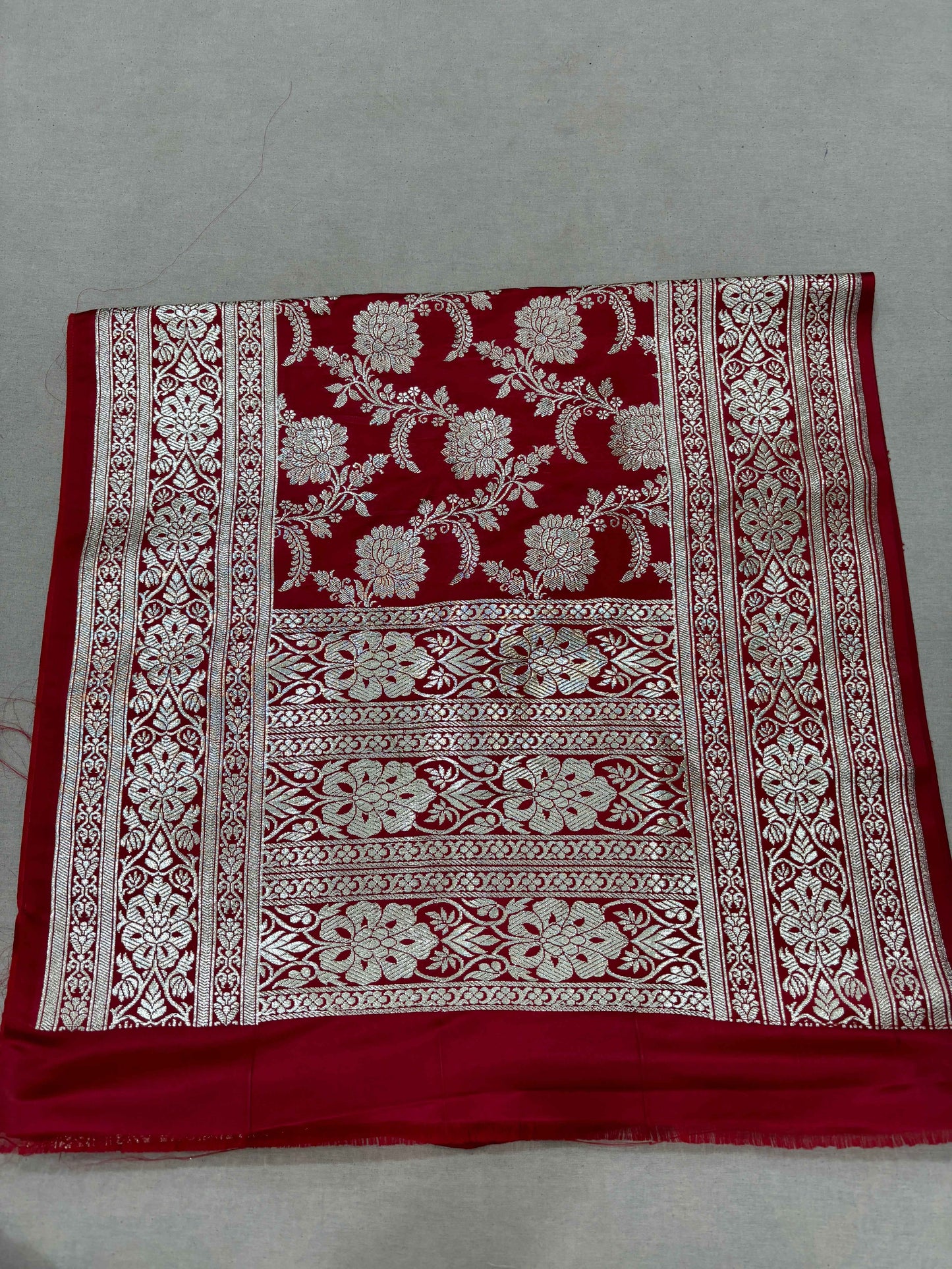 Red Banarasi katan handloom dupatta with floral vine motifs and wide patterned border