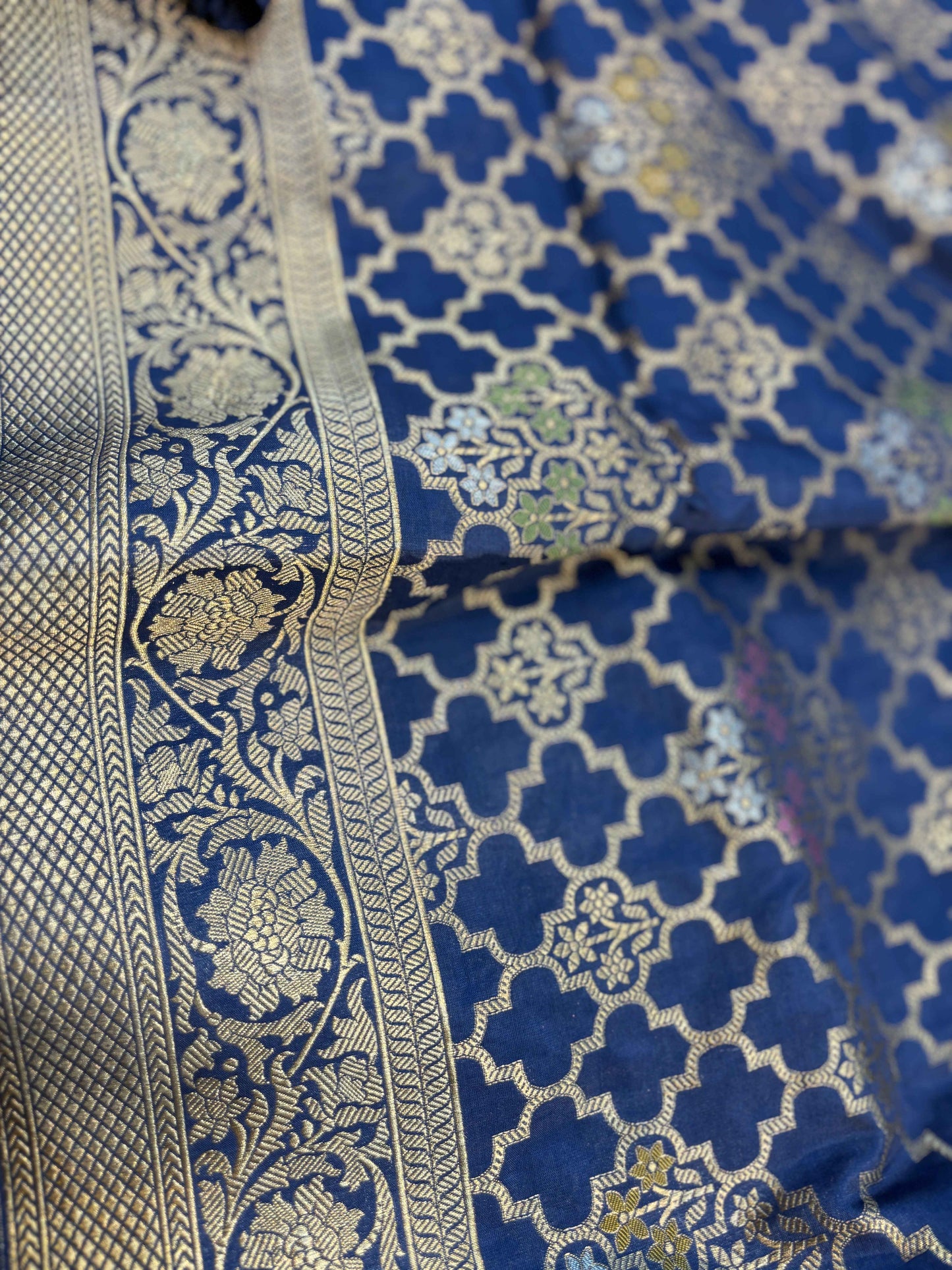 Blue saree edge with gold zari border and ornate floral panel