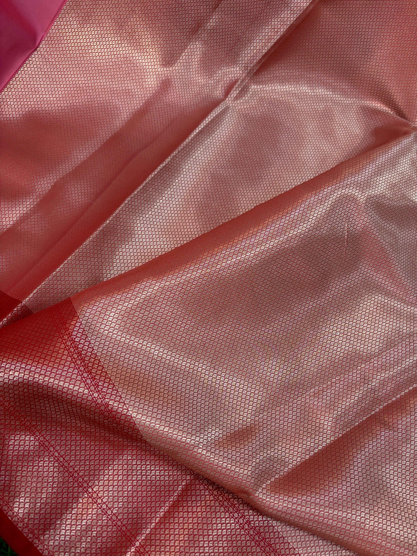 Pink semi katan Banarasi saree fabric close-up with woven silver-gold zari texture