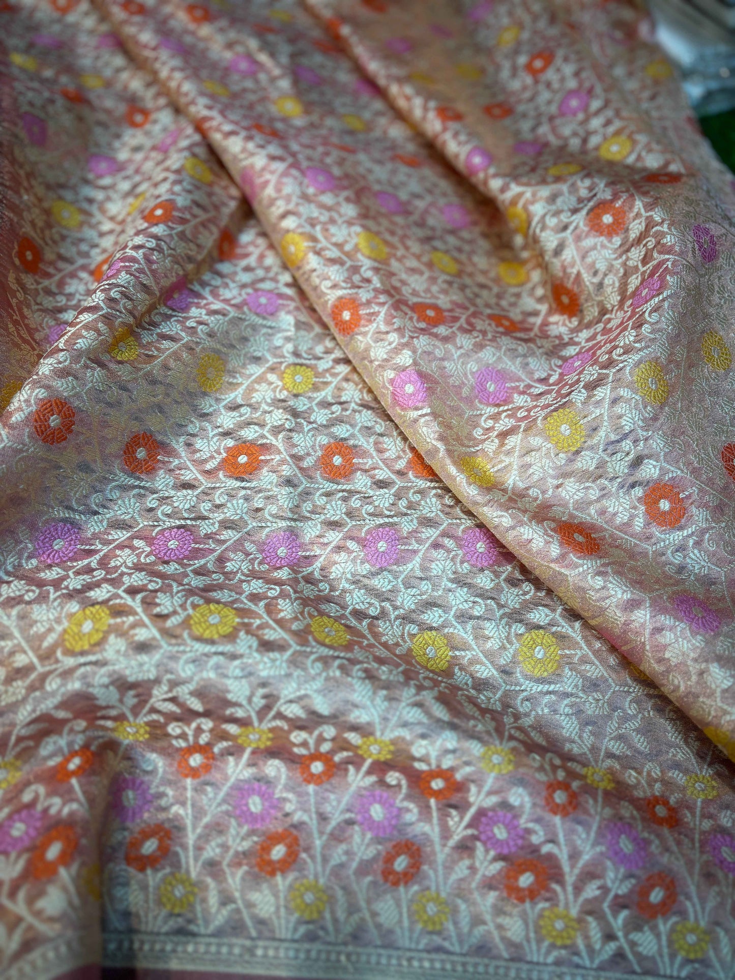 Lavender tissue saree in diagonal view with multicolor flower pattern and ornate edging