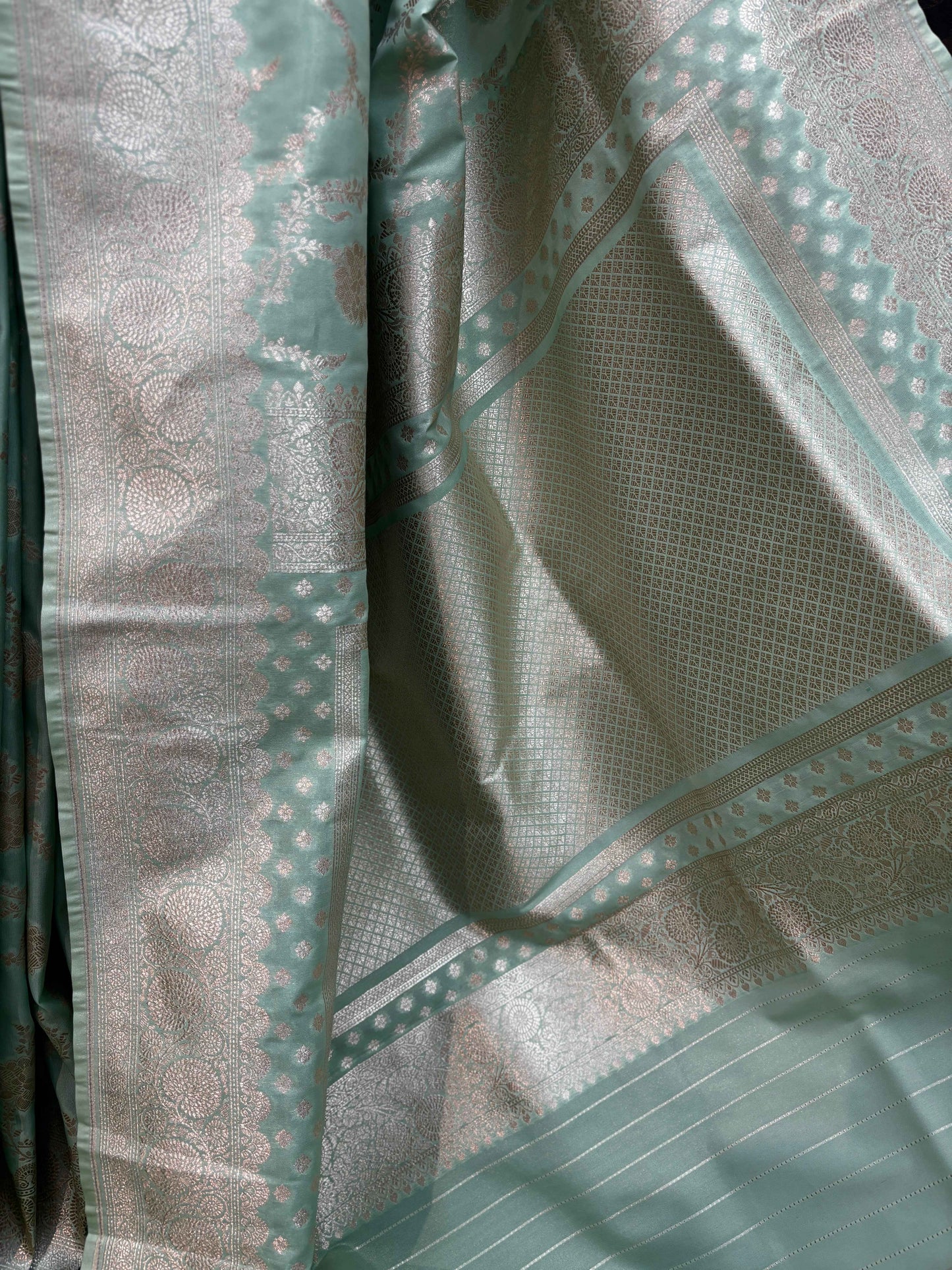 Banarasi saree pallu detail in pistachio green with gold zari weave and geometric motifs