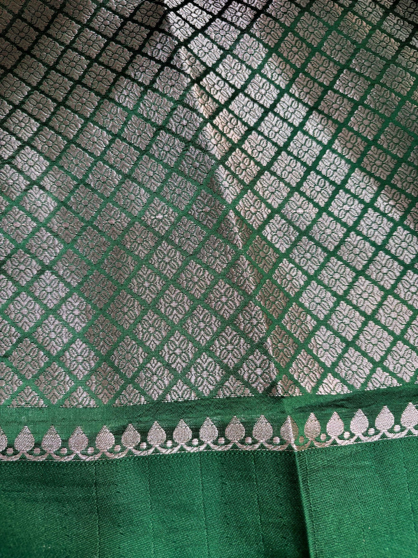 Rama green saree with lattice weave, white motifs, and decorative border