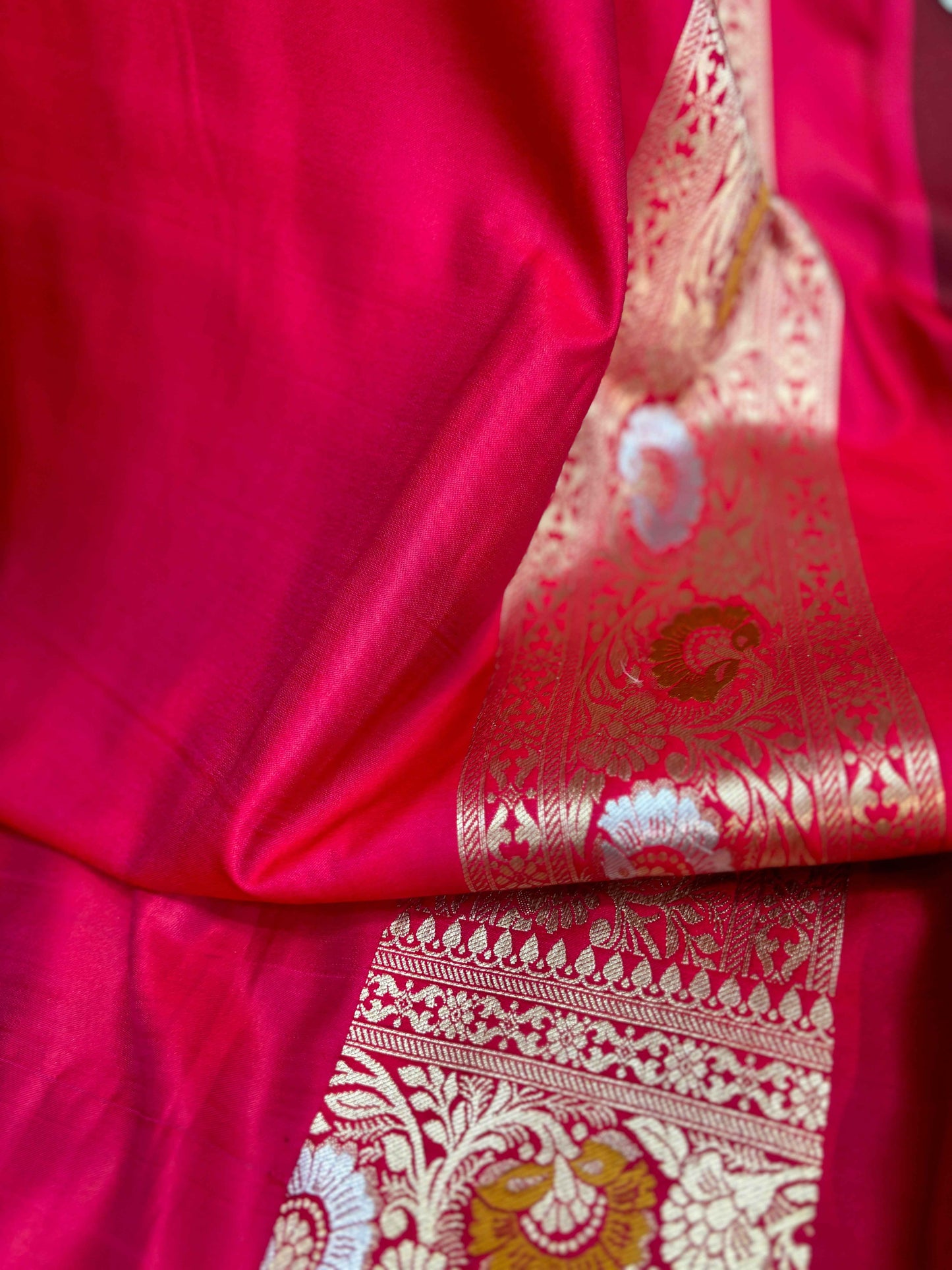 Red saree with gold-toned pallu border and floral motif panel, close view