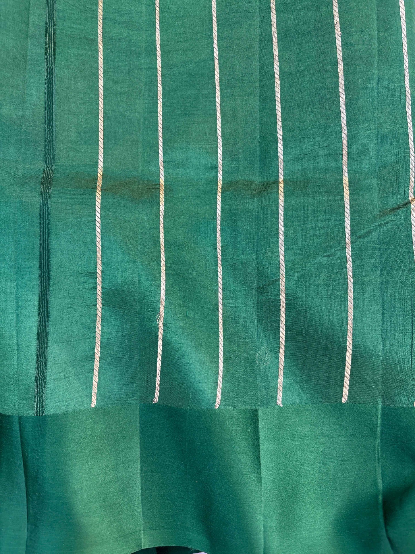 Green fabric with vertical white pinstripes and gathered panel