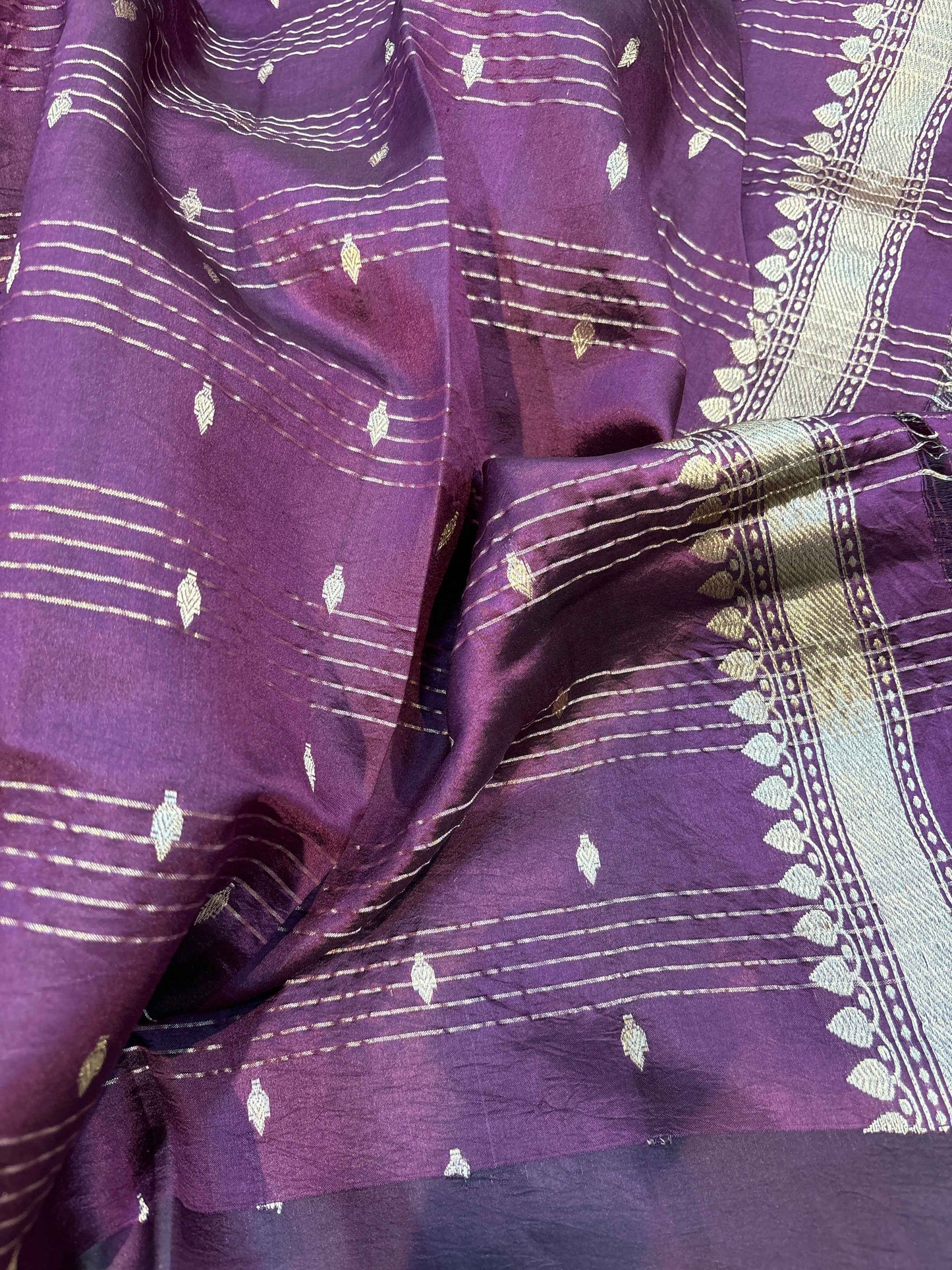 Wine saree with small gold motifs and fine grid stripe border, fabric close-up