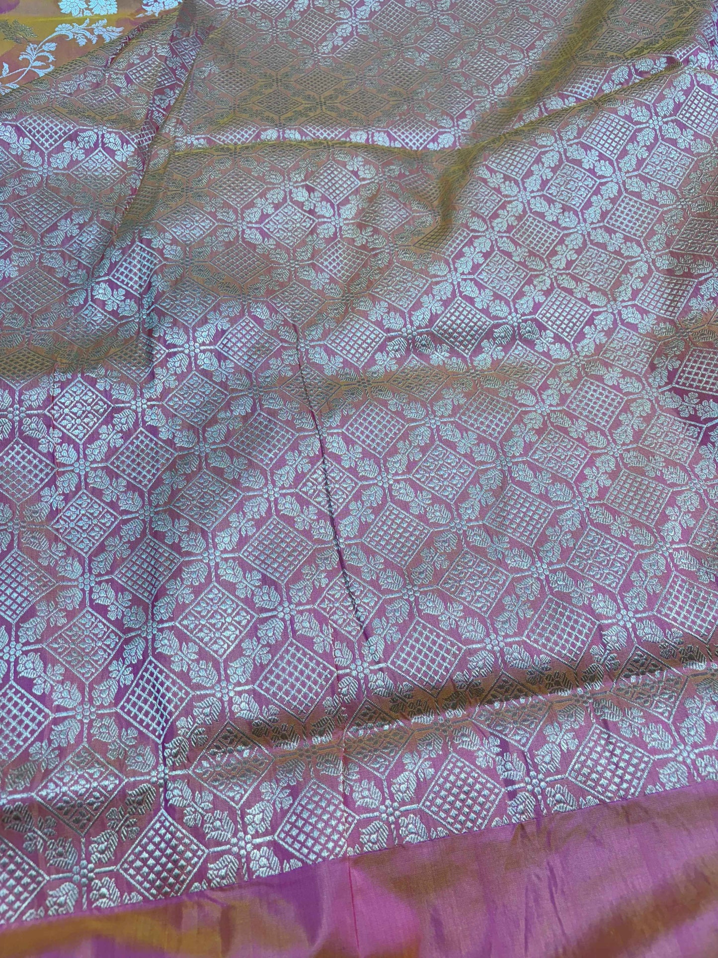 Banarasi handloom saree with pastel base, pink geometric motifs, and textured border