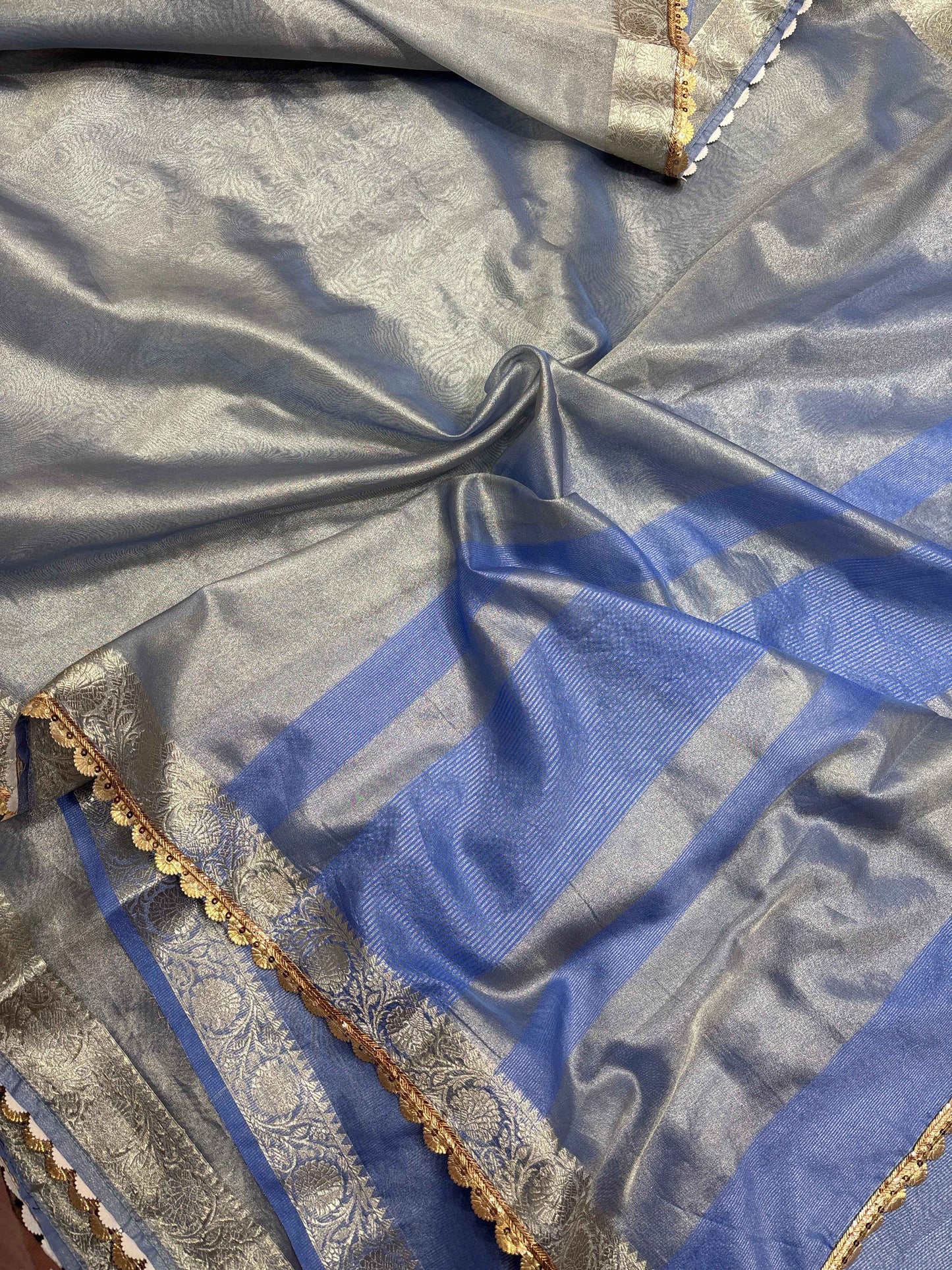 Blue tissue saree with gold-and-silver zari border lace