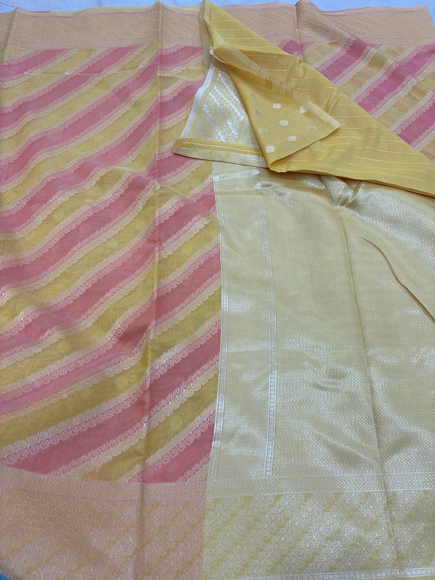 Yellow cotton Banarasi saree with pink and gold striped border