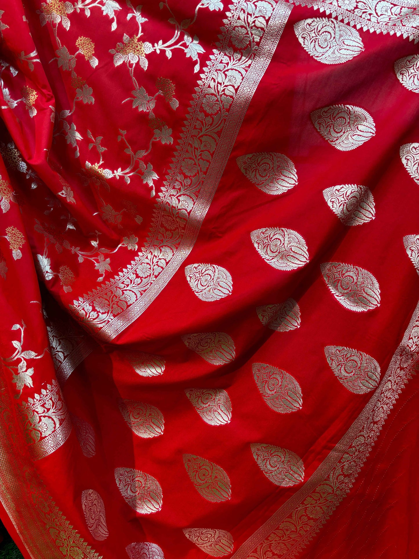 Red saree fabric with allover gold floral vines and silver leaf patterns