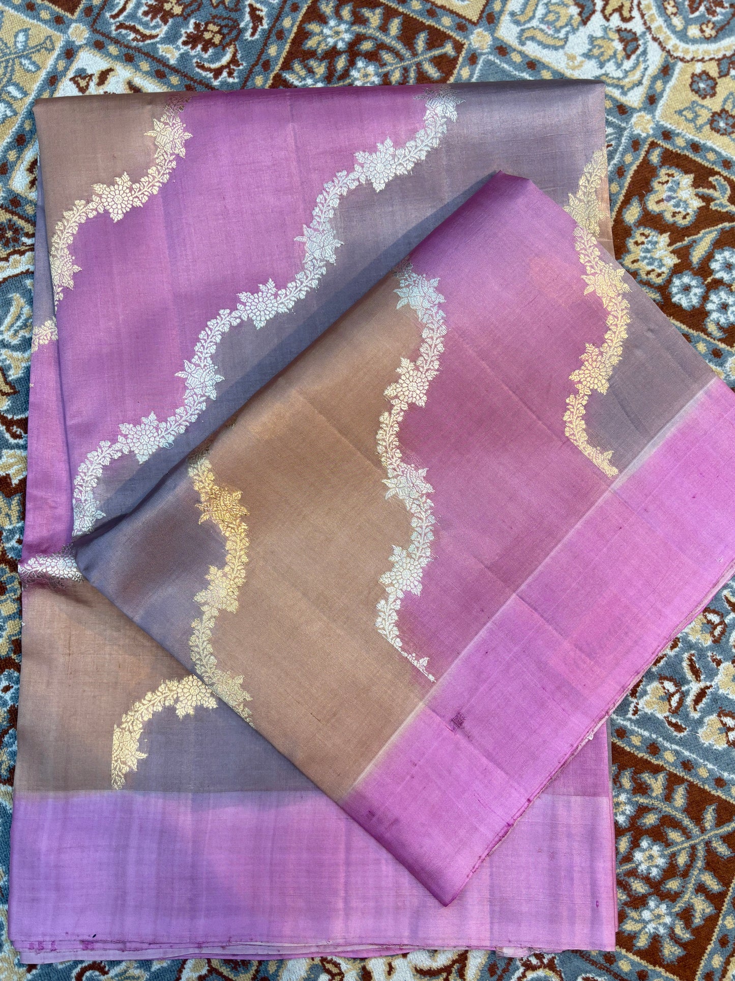 Lavender-gray Banarasi handloom saree with gold leaf motifs and zari border, folded