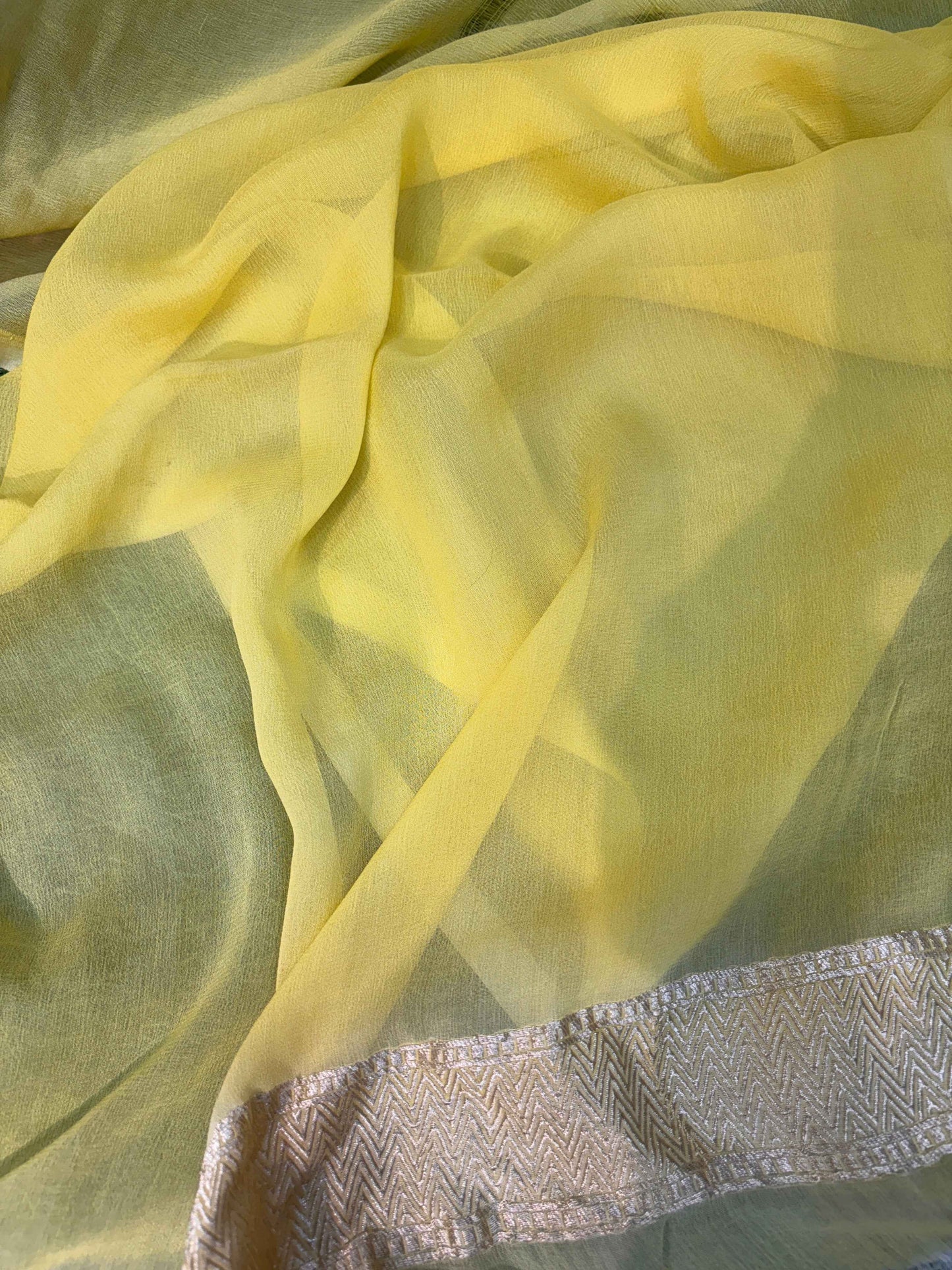 Lemon yellow georgette saree fabric with silver-toned woven border edge