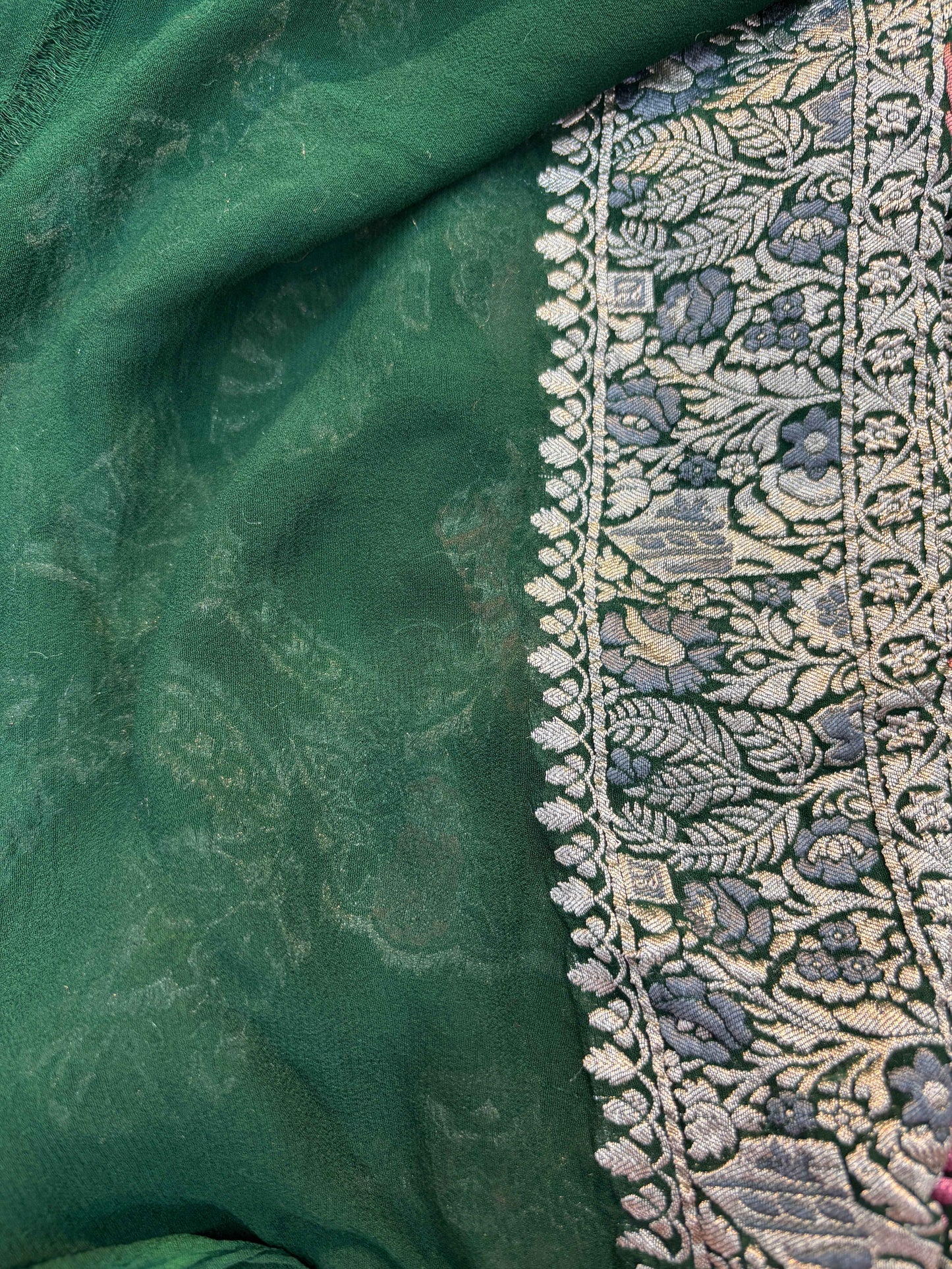 Green georgette saree with wide embroidered border and floral motifs