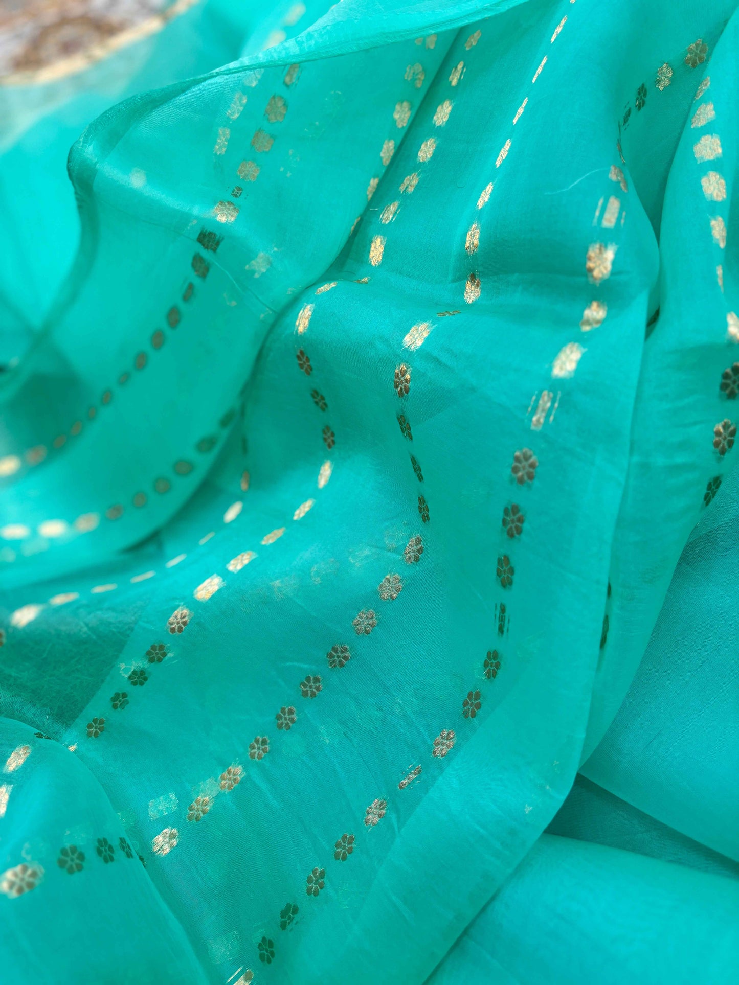 Turquoise saree with allover small gold dot and motif pattern
