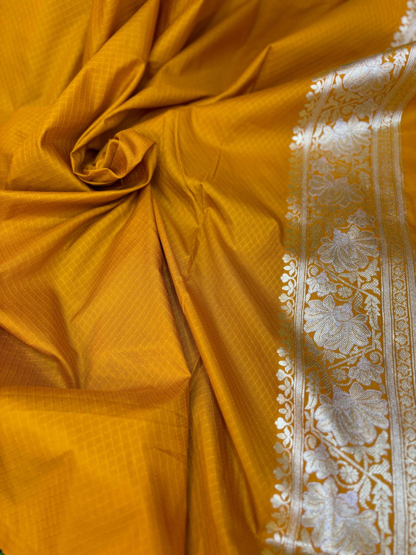 Mustard-yellow semi-silk saree with textured sheen and cream-gold brocade border