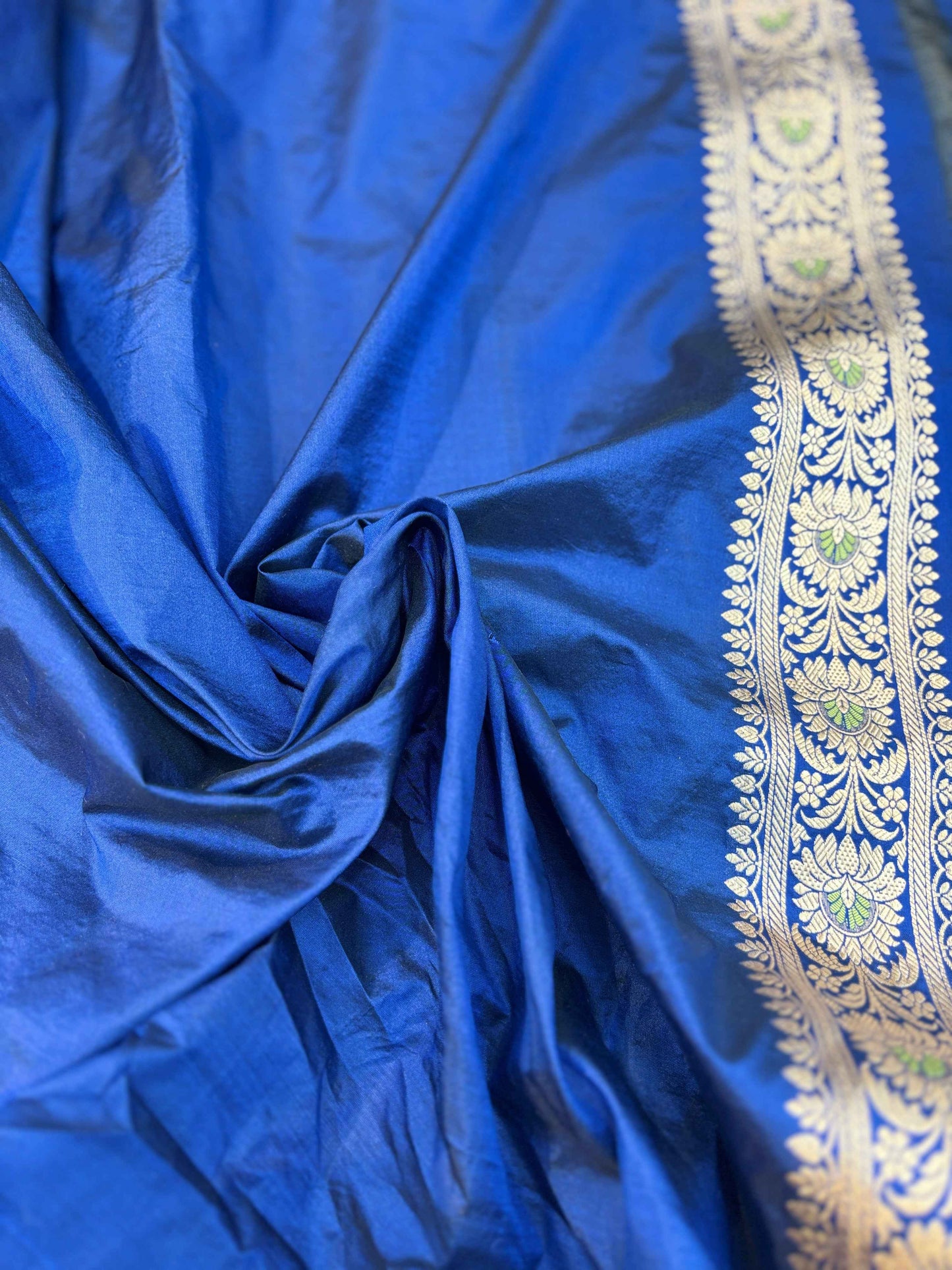 Royal blue saree fabric with gold embroidered edging border and decorative sheen