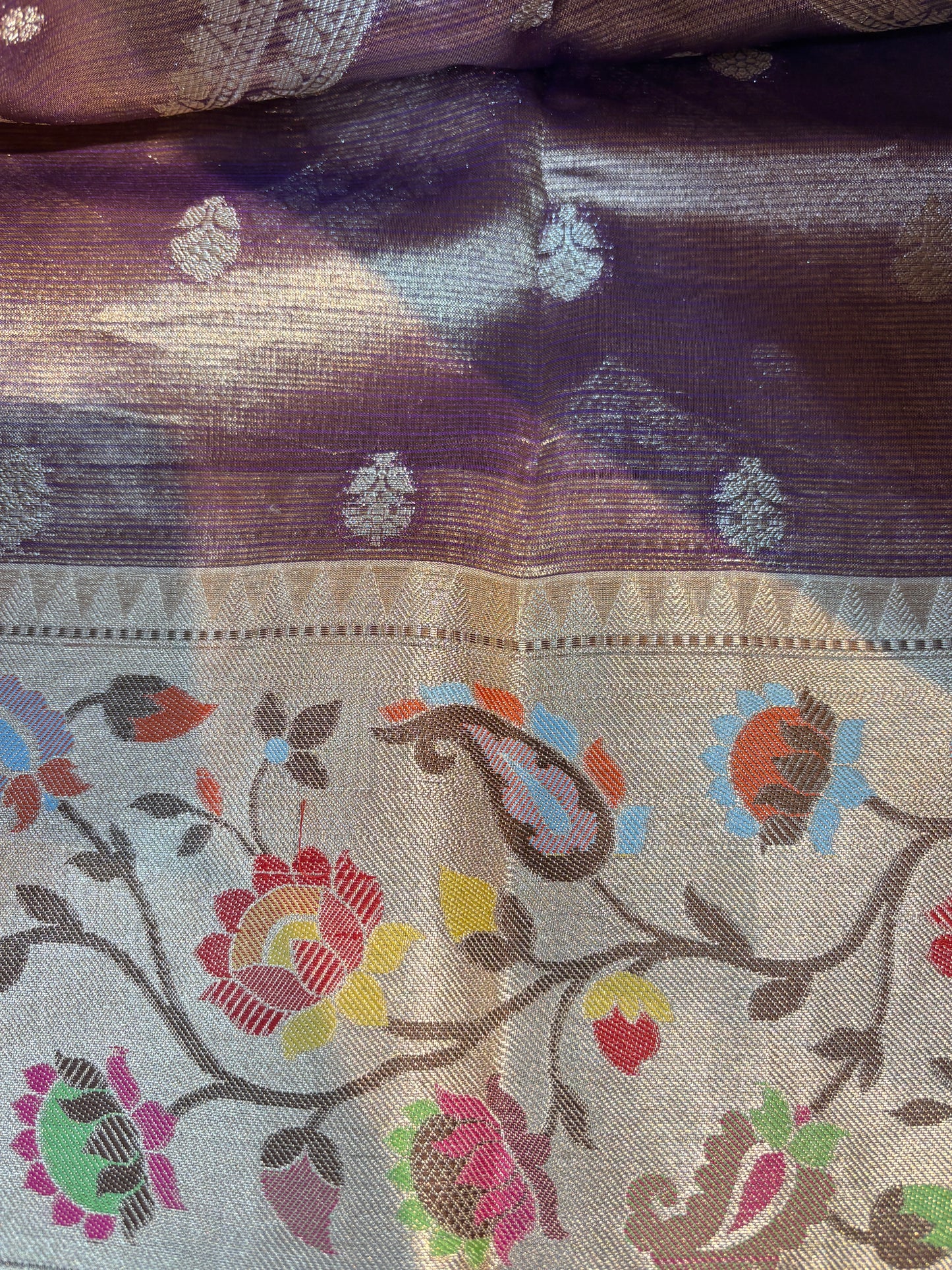 Banarasi handloom saree with floral vine border and metallic base, multicolor accents