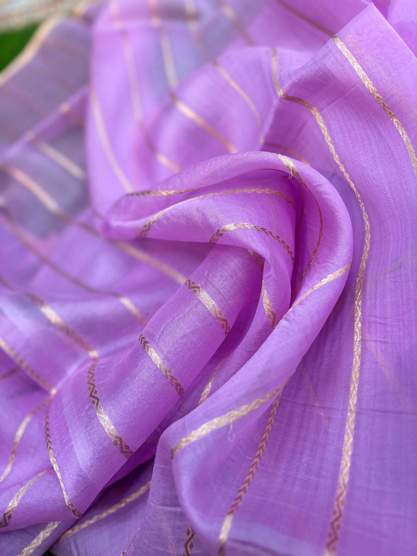Lavender silk saree close-up with gold zari lines and delicate woven texture