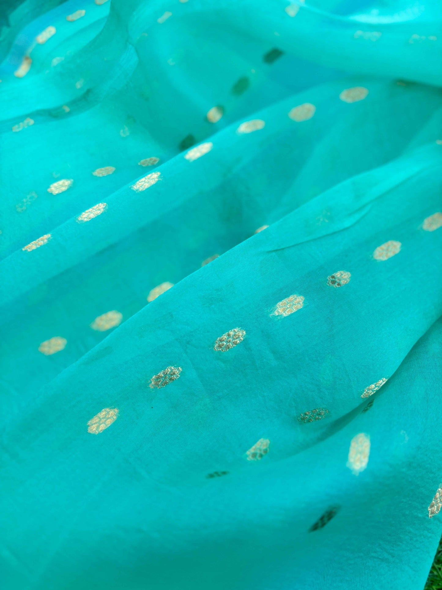 Sky blue Banarasi saree with small gold dotted motifs and woven texture