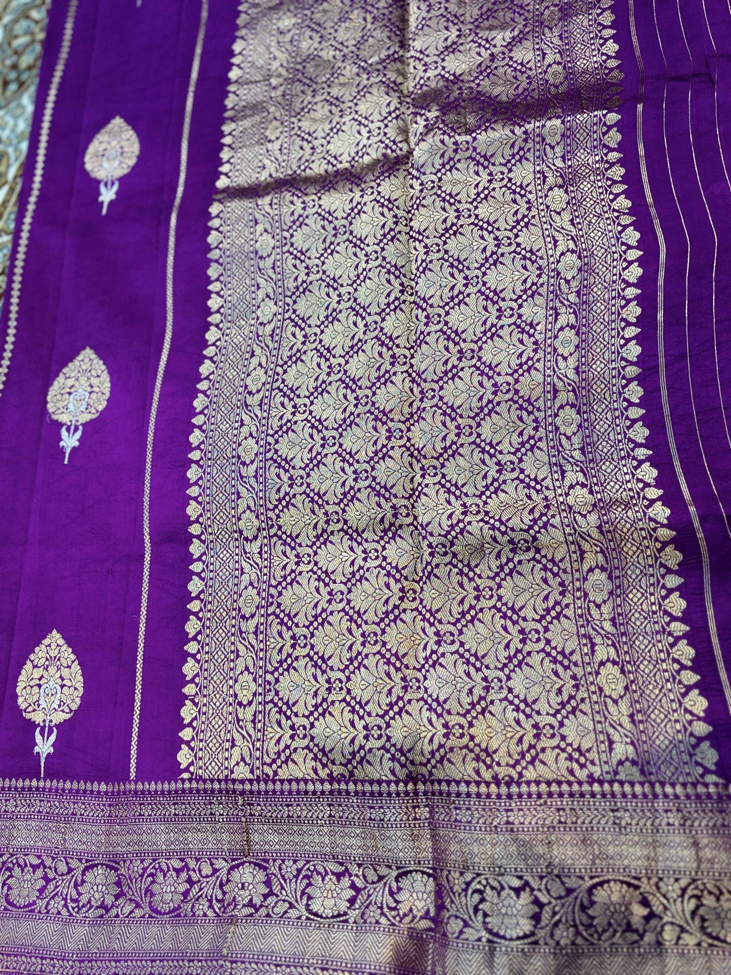 Purple saree panel with dense floral jaal pattern and wide zari border