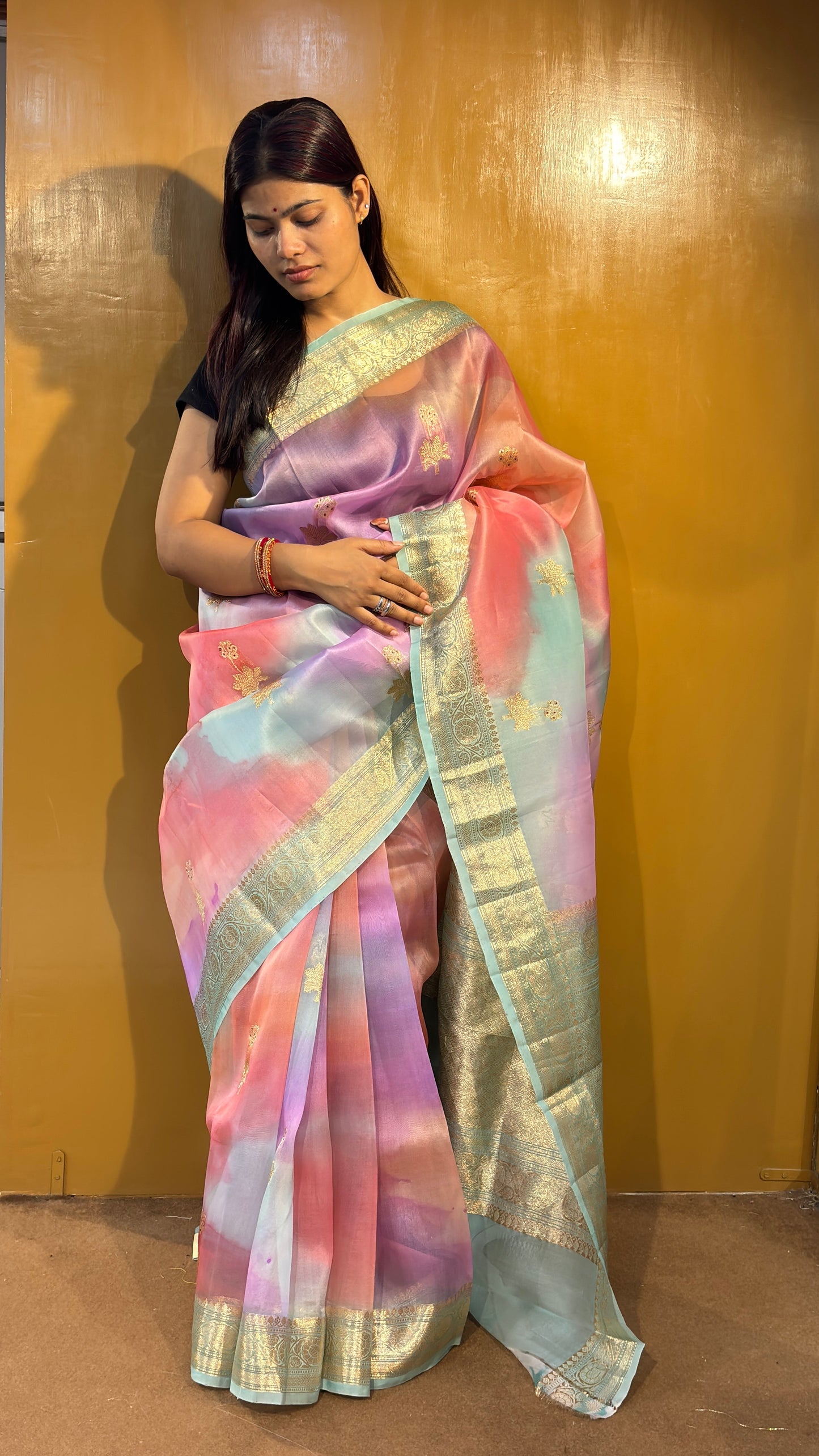 Pastel pink and blue saree with gold border and floral motifs