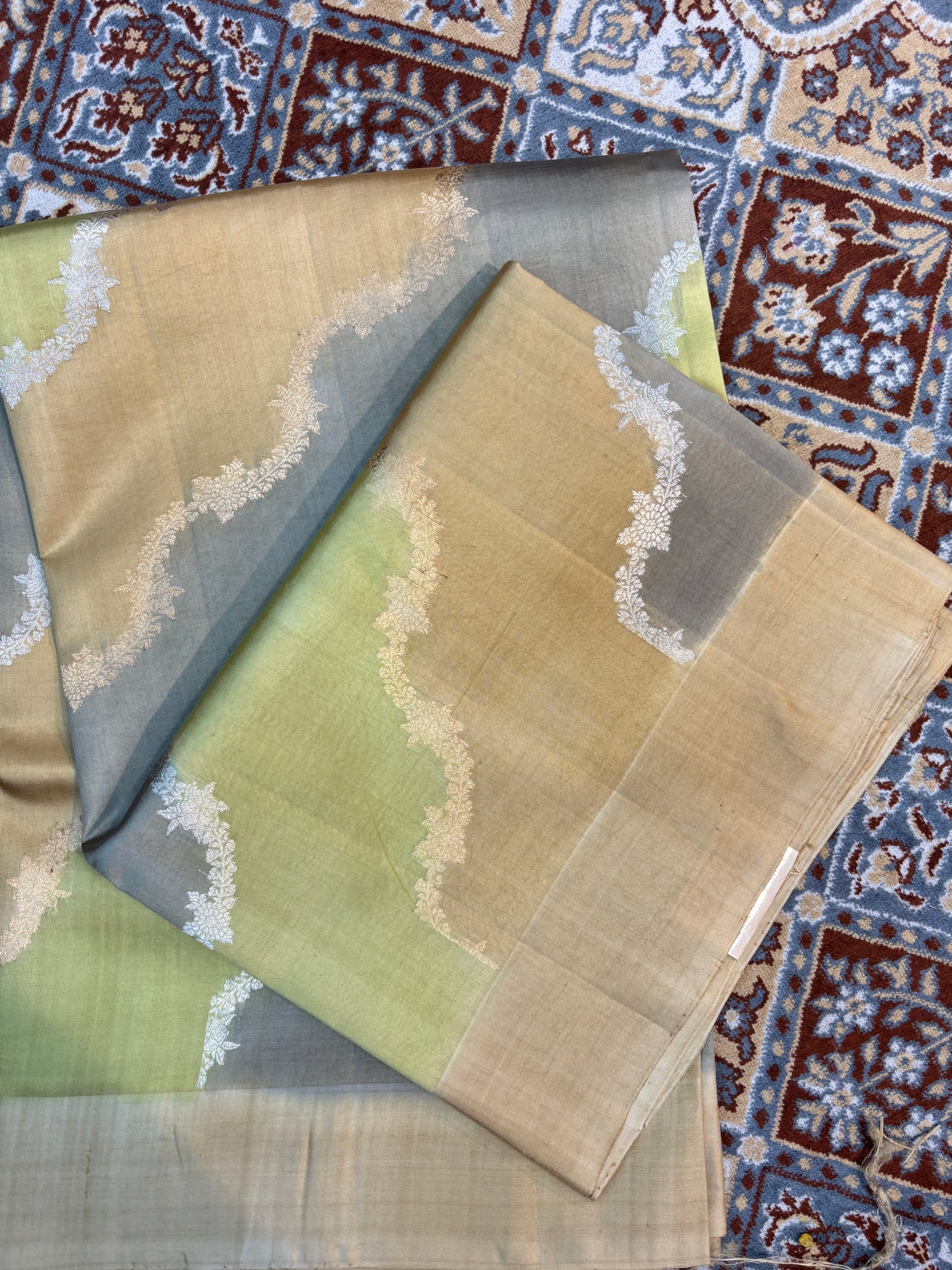 Green-gray handloom saree with white patterned border and pallu