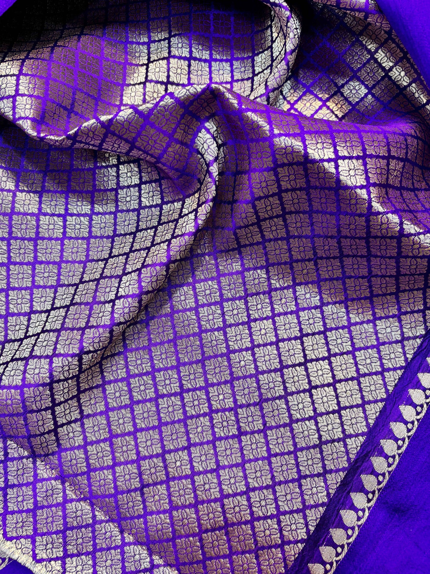 Purple handloom saree drape with white check grid pattern and zari trim