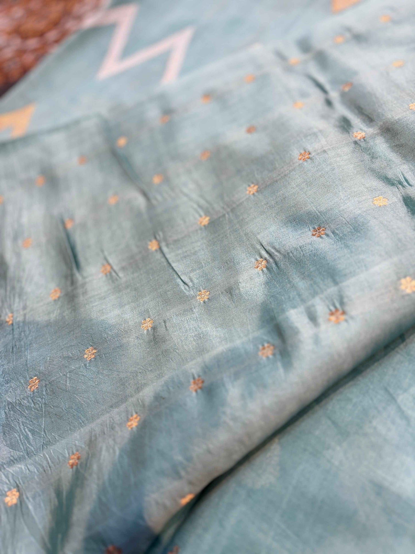Powder blue saree with scattered tiny orange floral sprigs