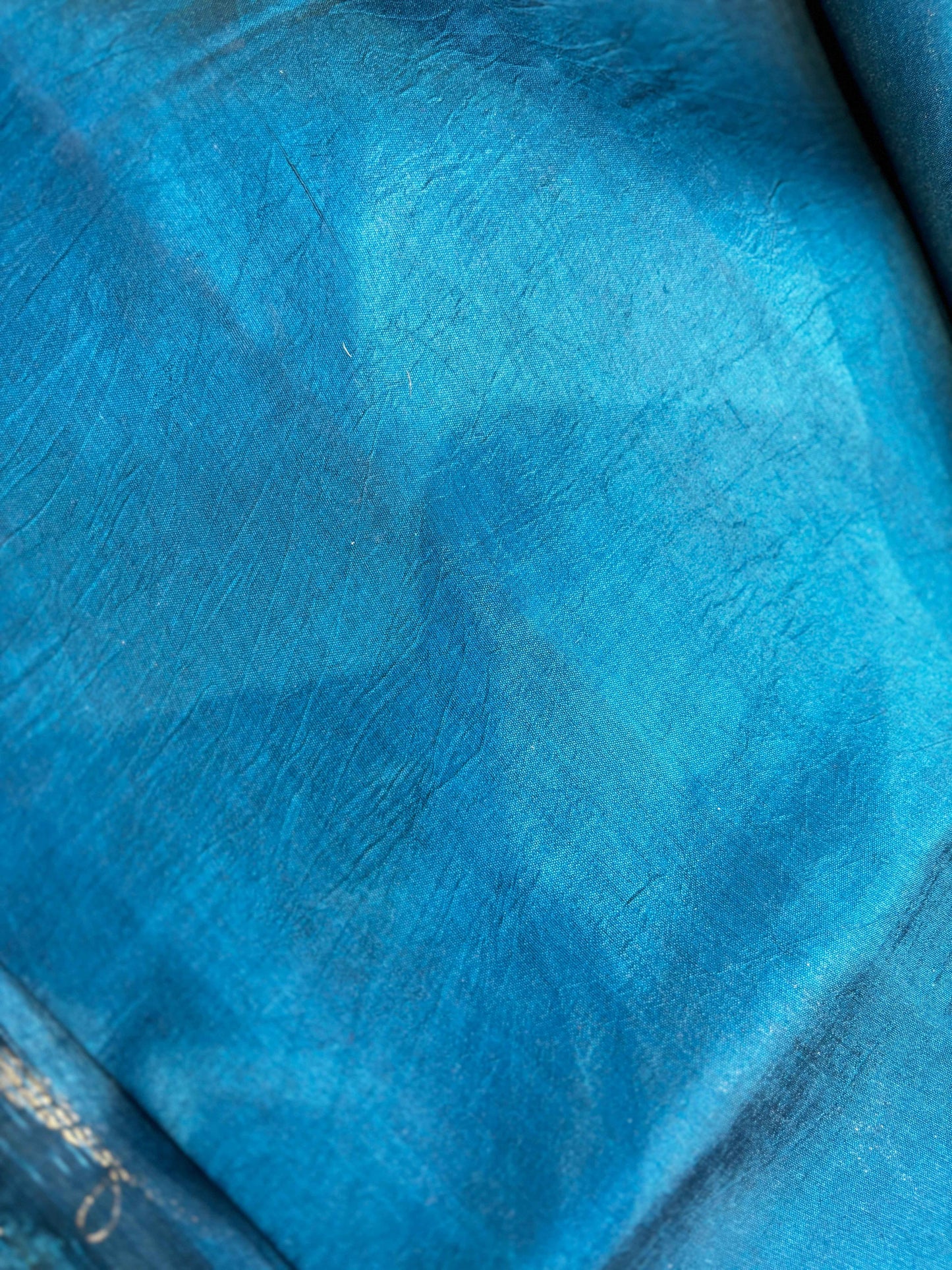 Sky blue sari fabric with fine woven texture, no visible embellishment