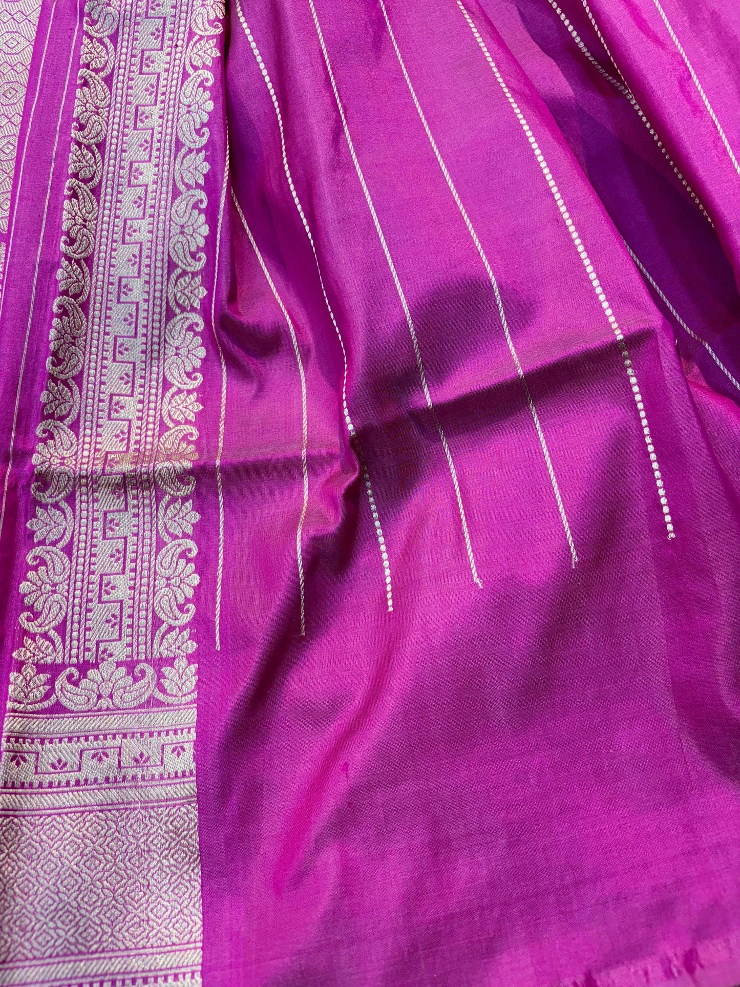 Purple saree pallu with ornate zari border and fine striped pattern