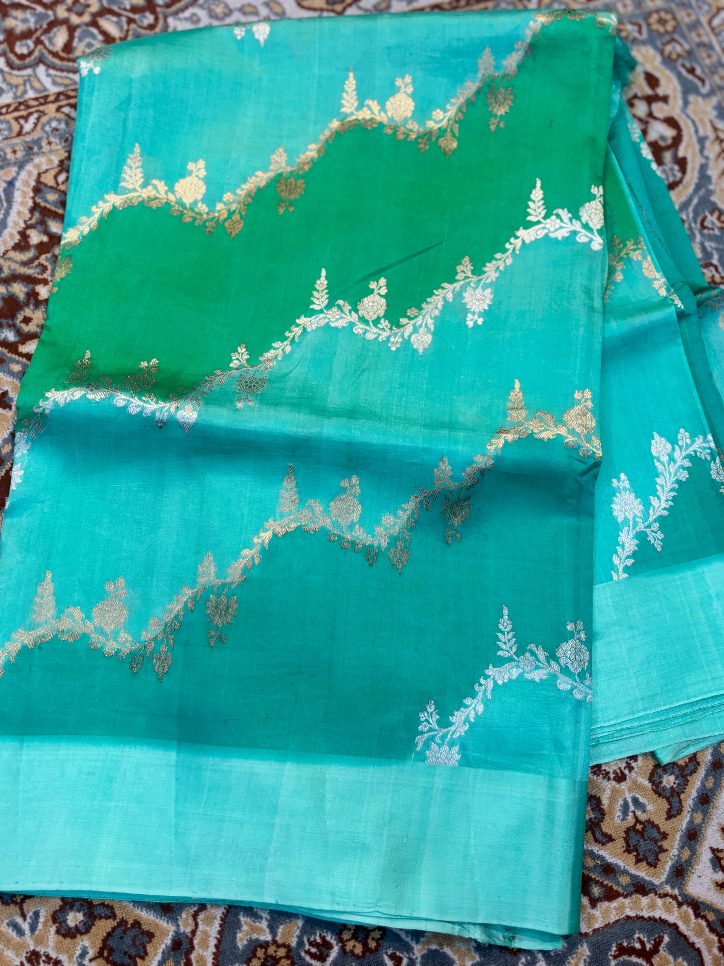 Banarasi handloom saree in teal with gold leaf-like motifs and zari border