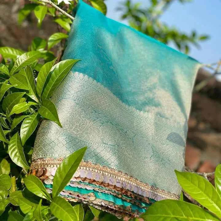 Teal silk saree with gold woven border and multicolor lace trim