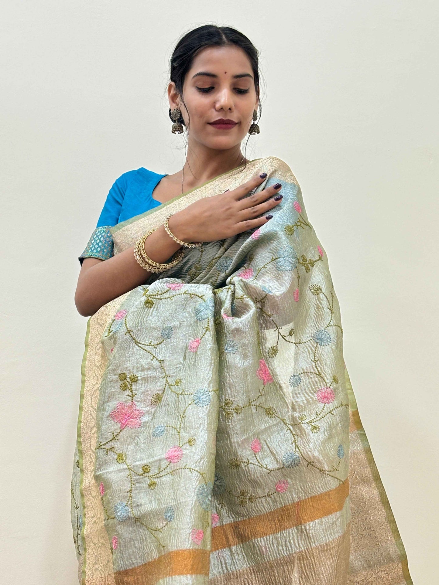 Banarasi handloom saree in light green with gold border and floral embroidery