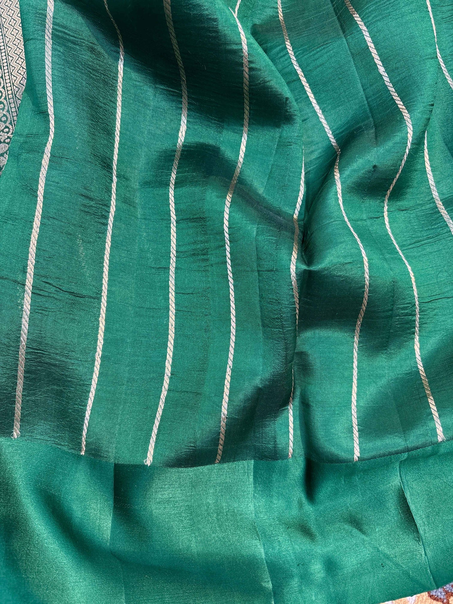Rama green handloom saree fabric close-up with vertical textured stripes