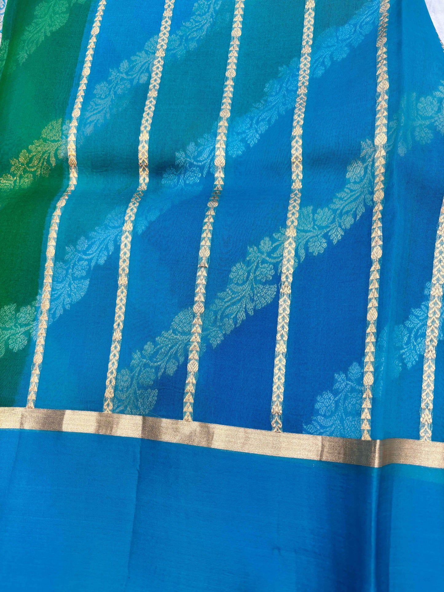 Blue saree with vertical gold zari lines and ornate pattern