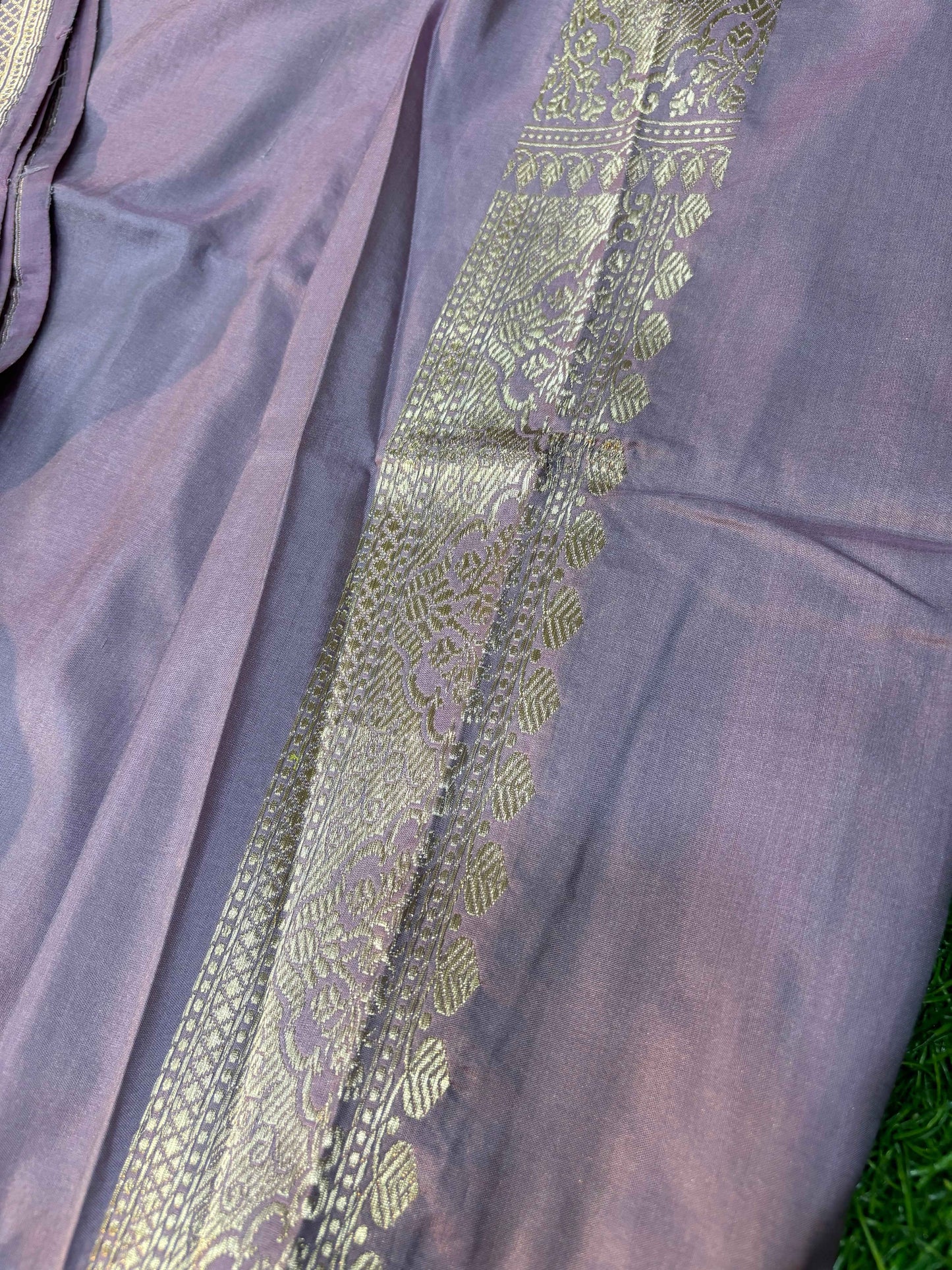 Light lavender saree with wide zari border and vertical floral motifs on pallu