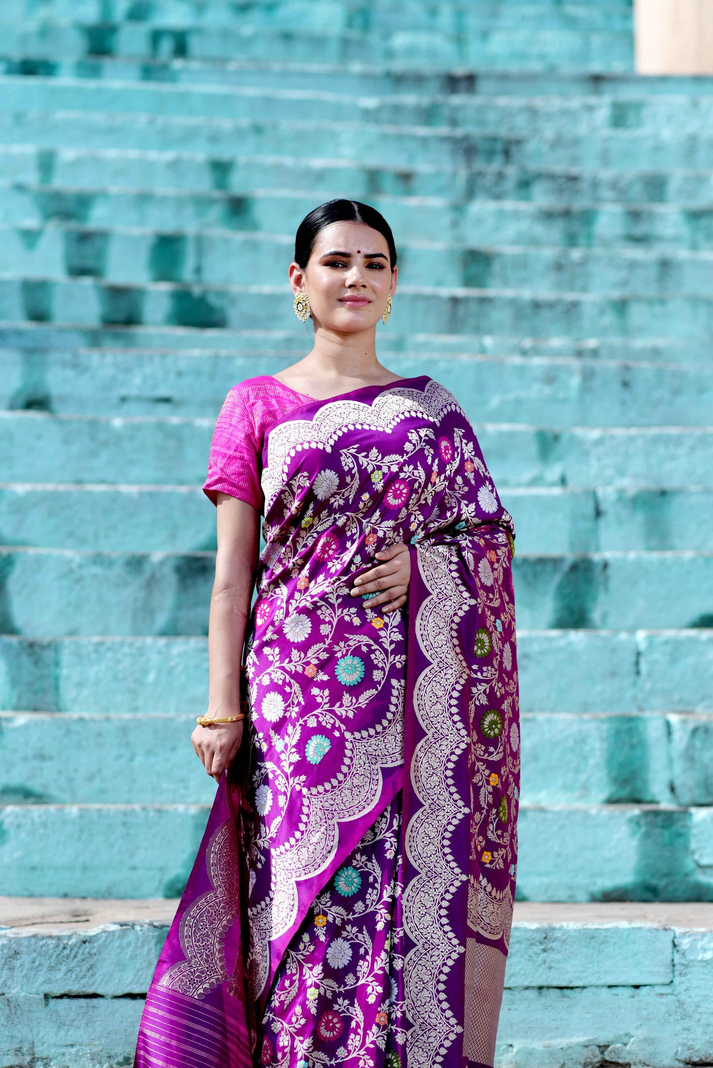 Purple handloom saree with ornate paisley and floral motifs, draped over dark purple