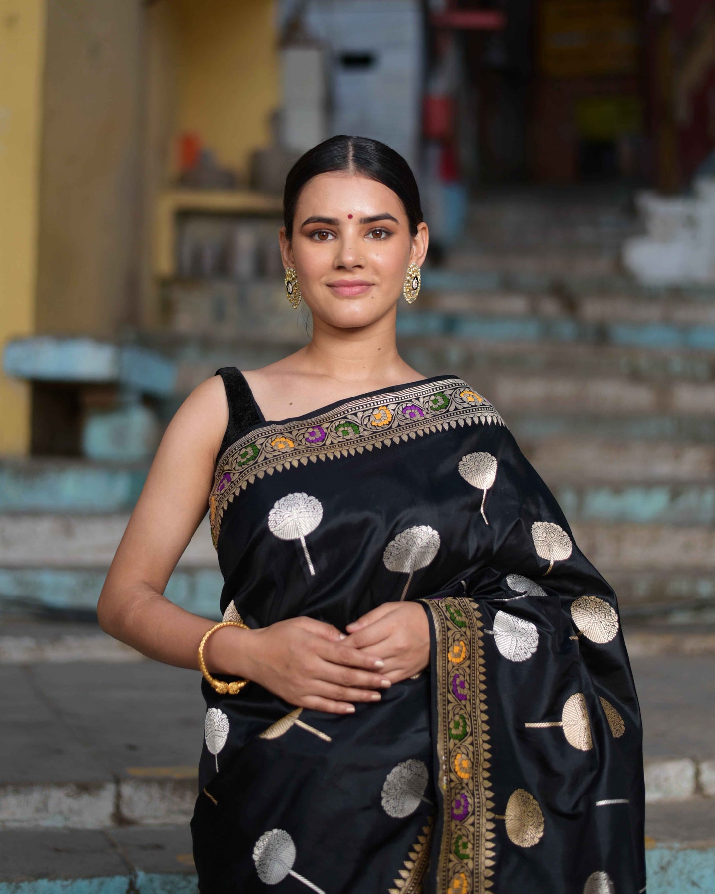 Black katan silk saree with white and gold circle motifs and multicolor border