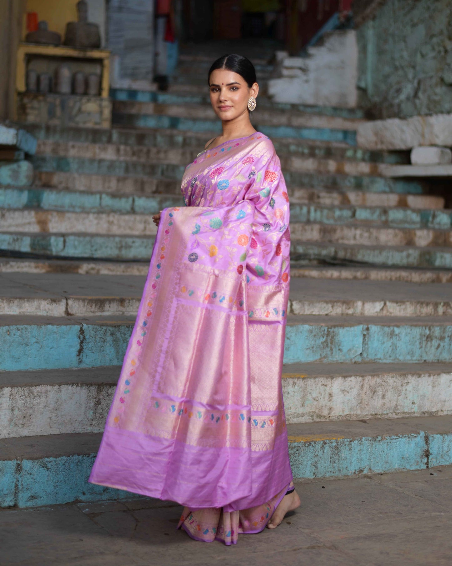 Baby pink saree with purple border and floral motifs, full-length side drape