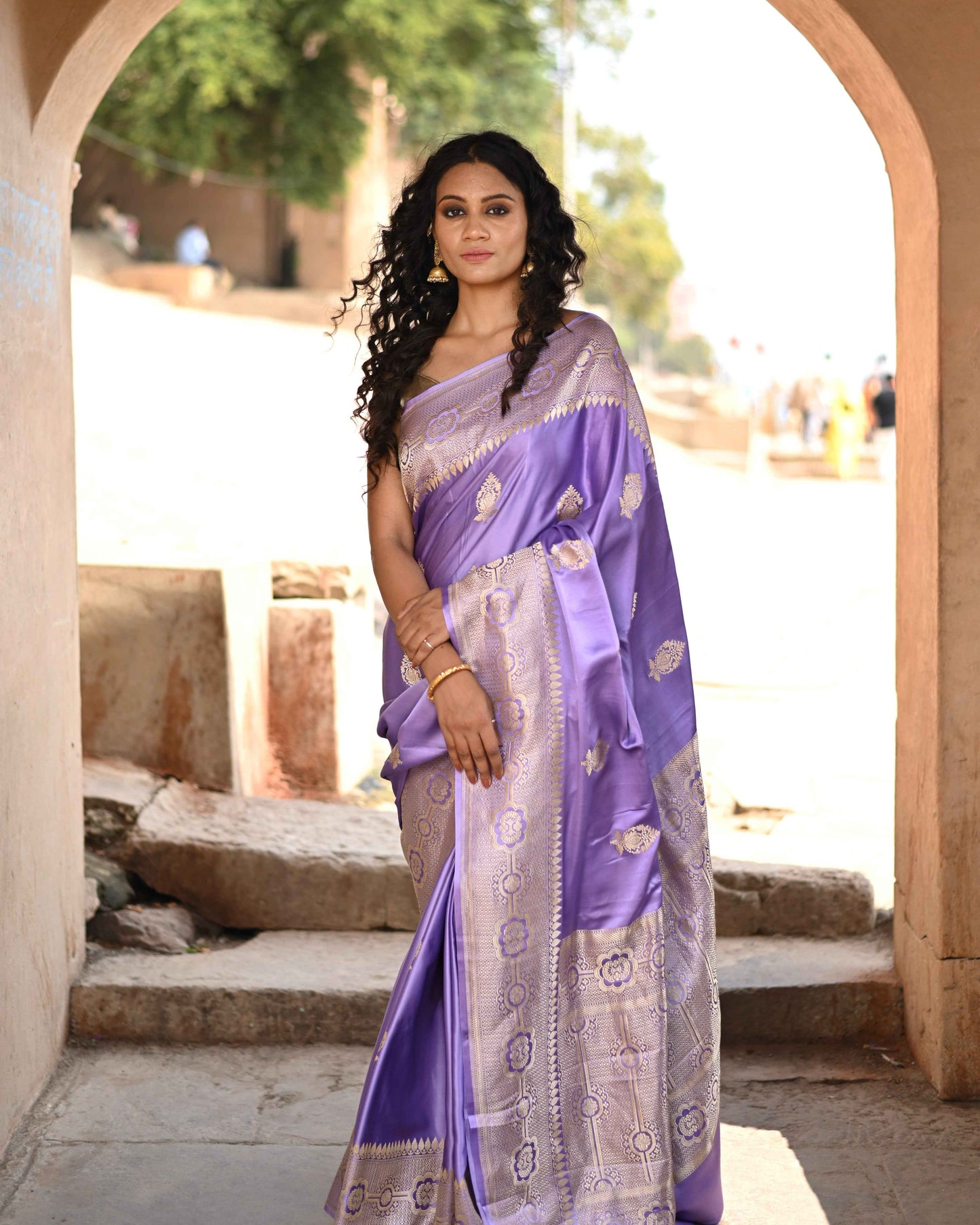 Purple Banarasi-style saree with gold border and woven motifs