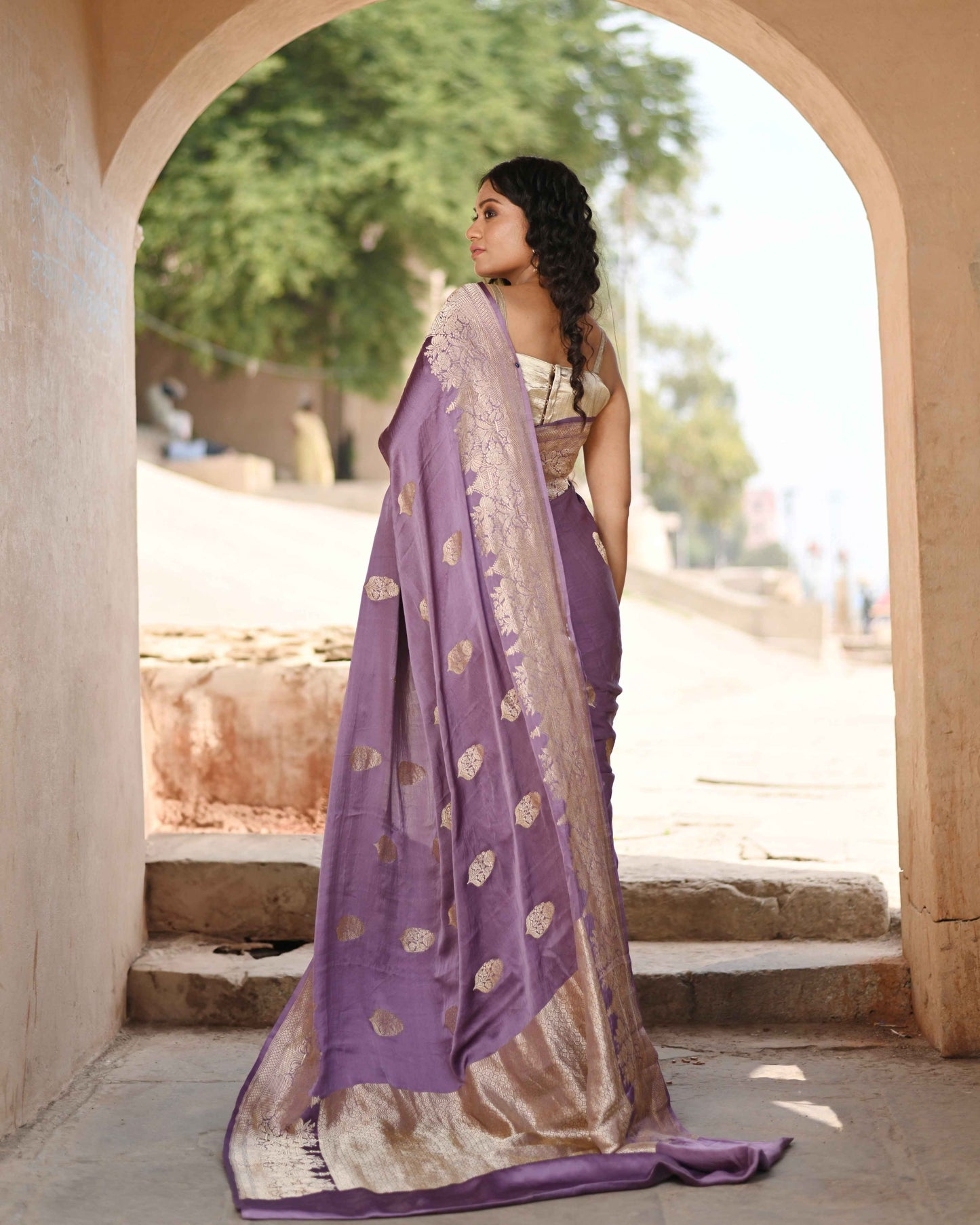Purple saree with gold bootas and zari-style border, draped in full length