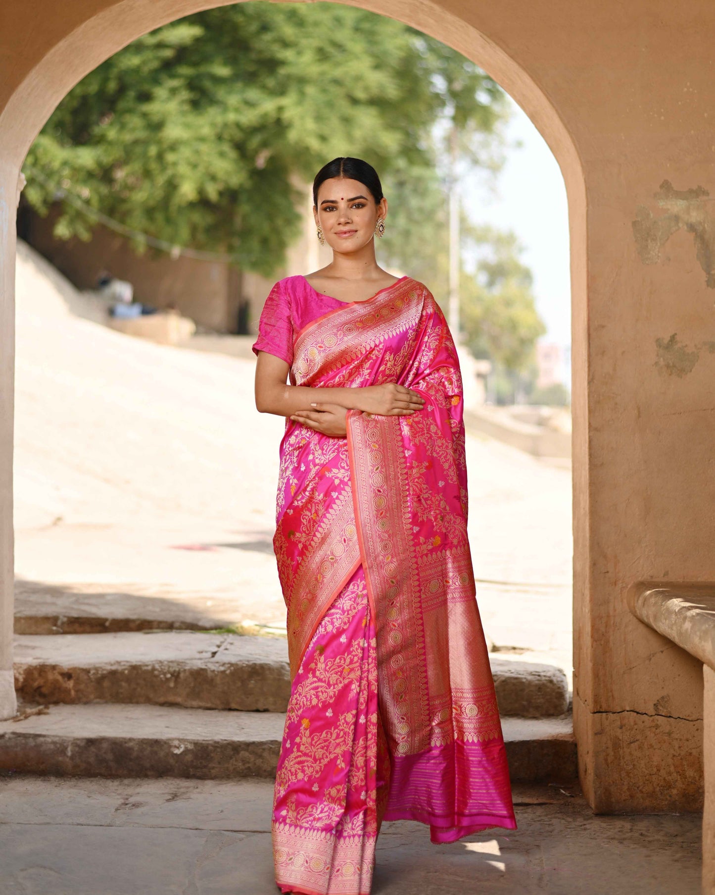 Dark pink silk saree with gold zari border and allover woven motifs