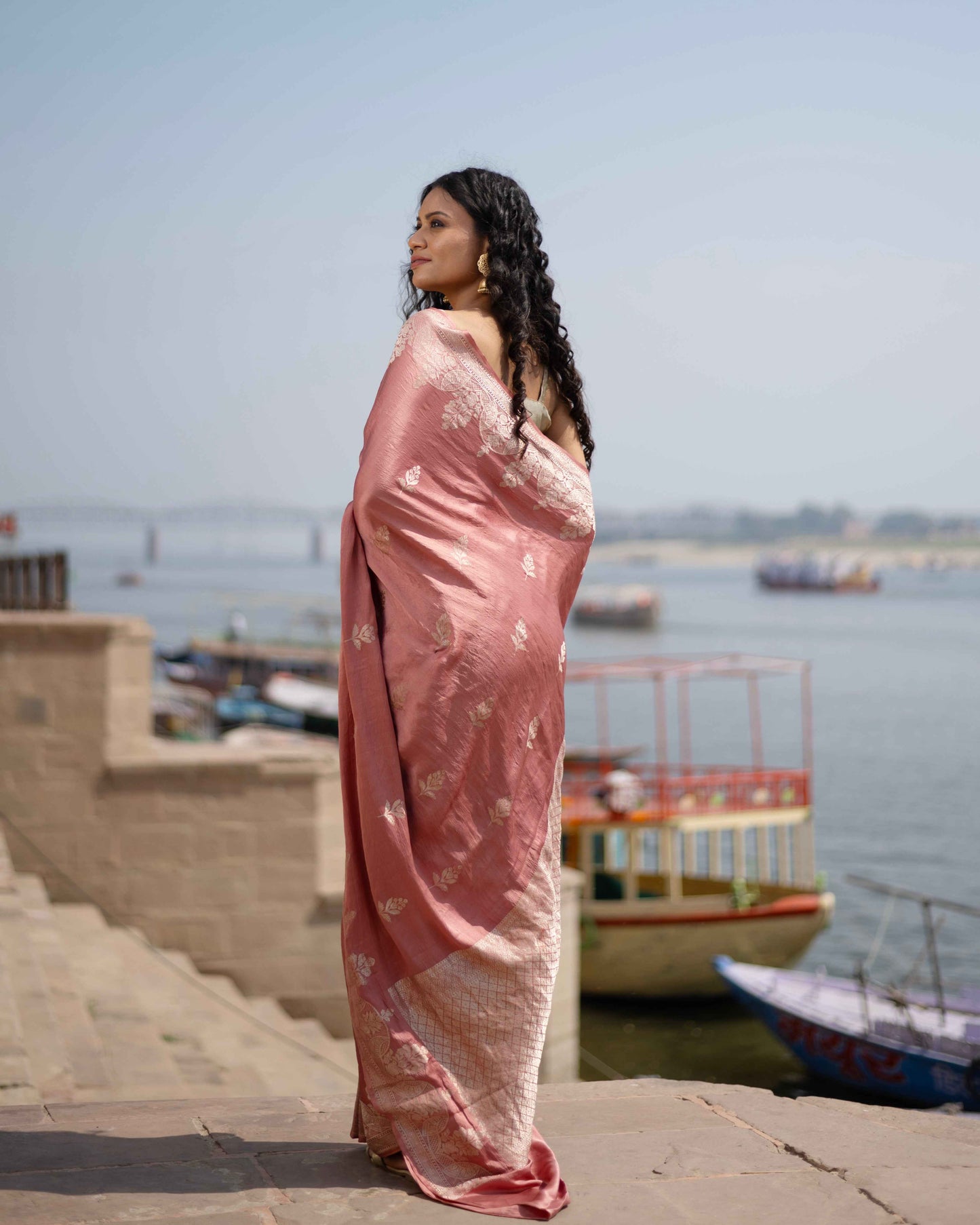 Peach pink saree with scattered silver boota motifs and pallu sheen, side profile drape