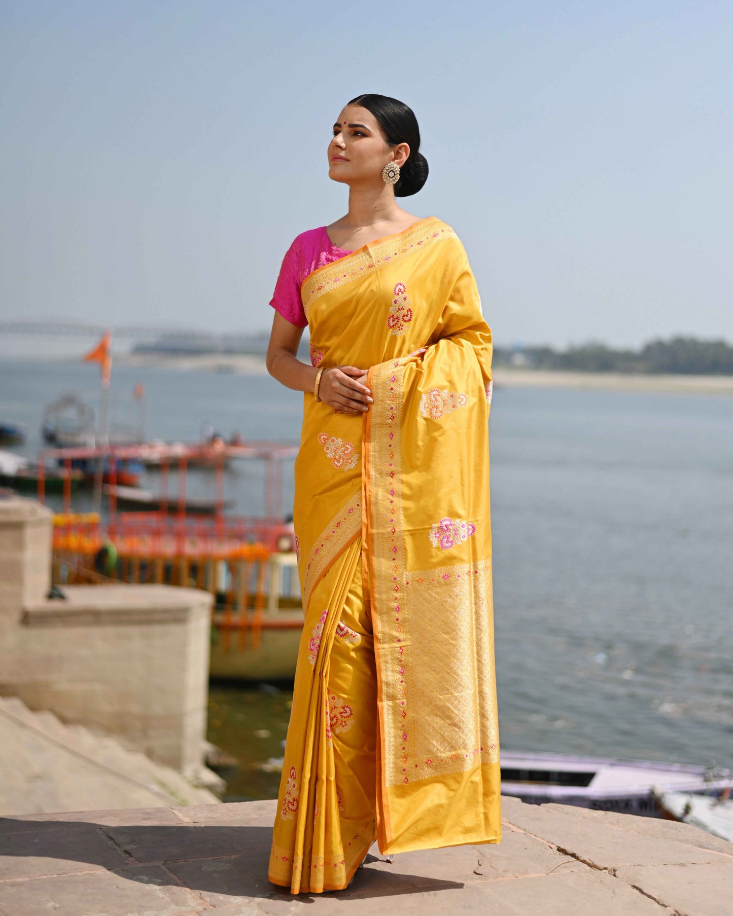 Yellow silk saree with pink motifs and gold border