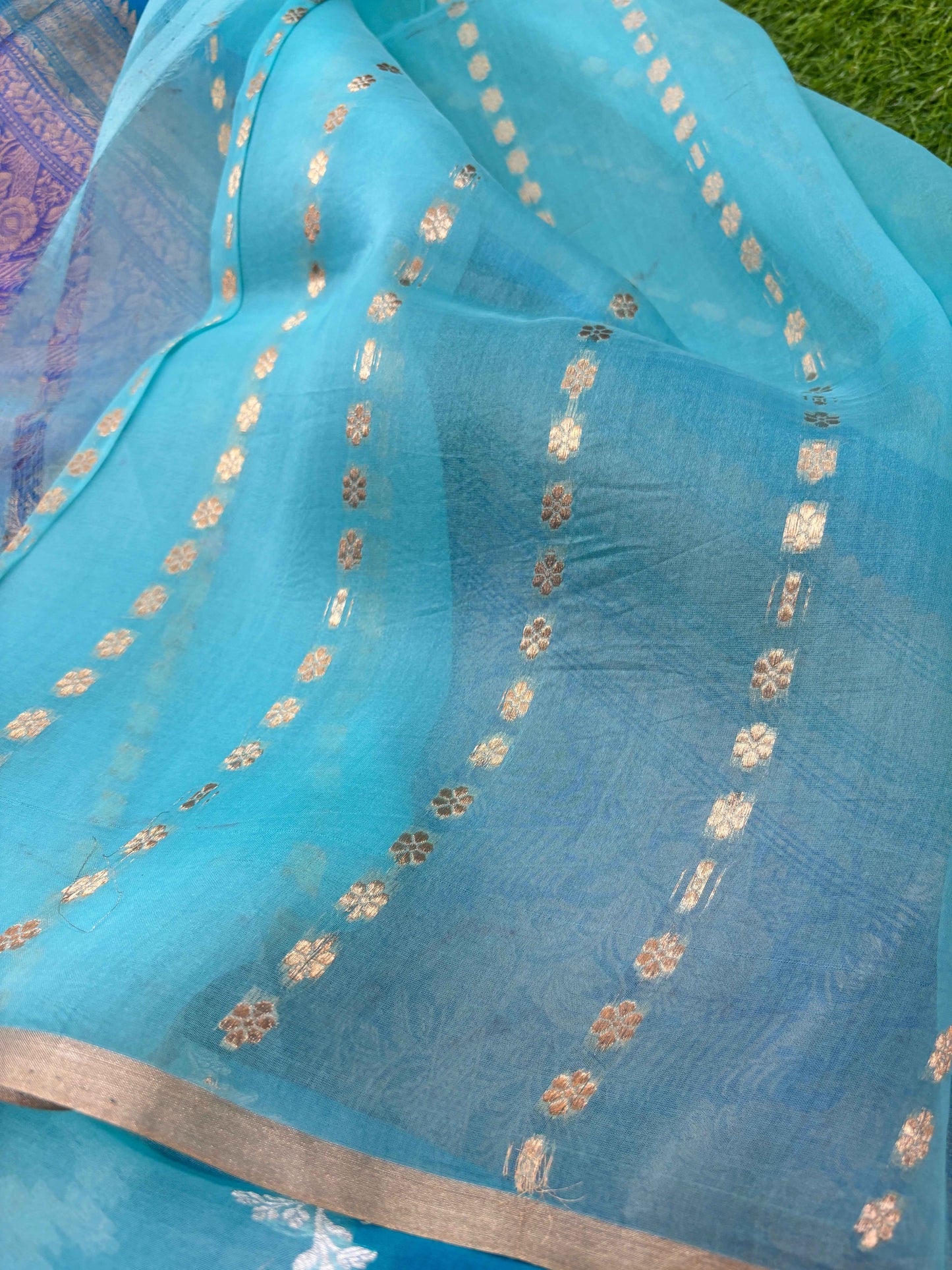 Light blue Banarasi saree with scattered gold motifs and cream zari border